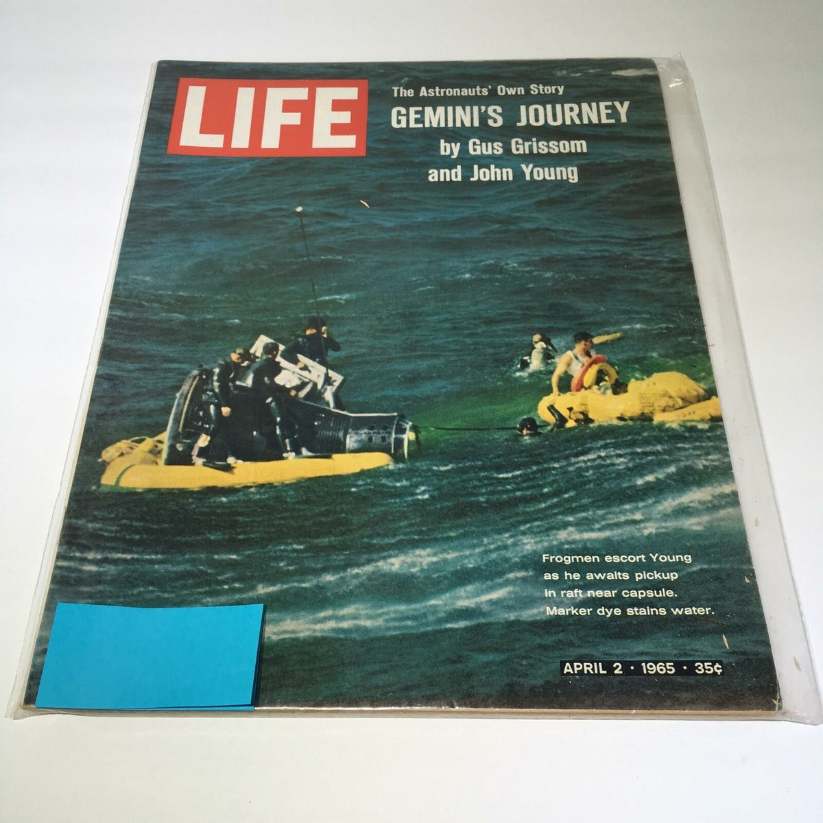 Cover of VTG Life Magazine from April 2, 1965, featuring the title 'Frogmen Escort Young Awaits In Raft Near Cap.' The image depicts a dramatic scene of astronauts' journey with individuals in a yellow raft on the ocean, showcasing vintage photography.