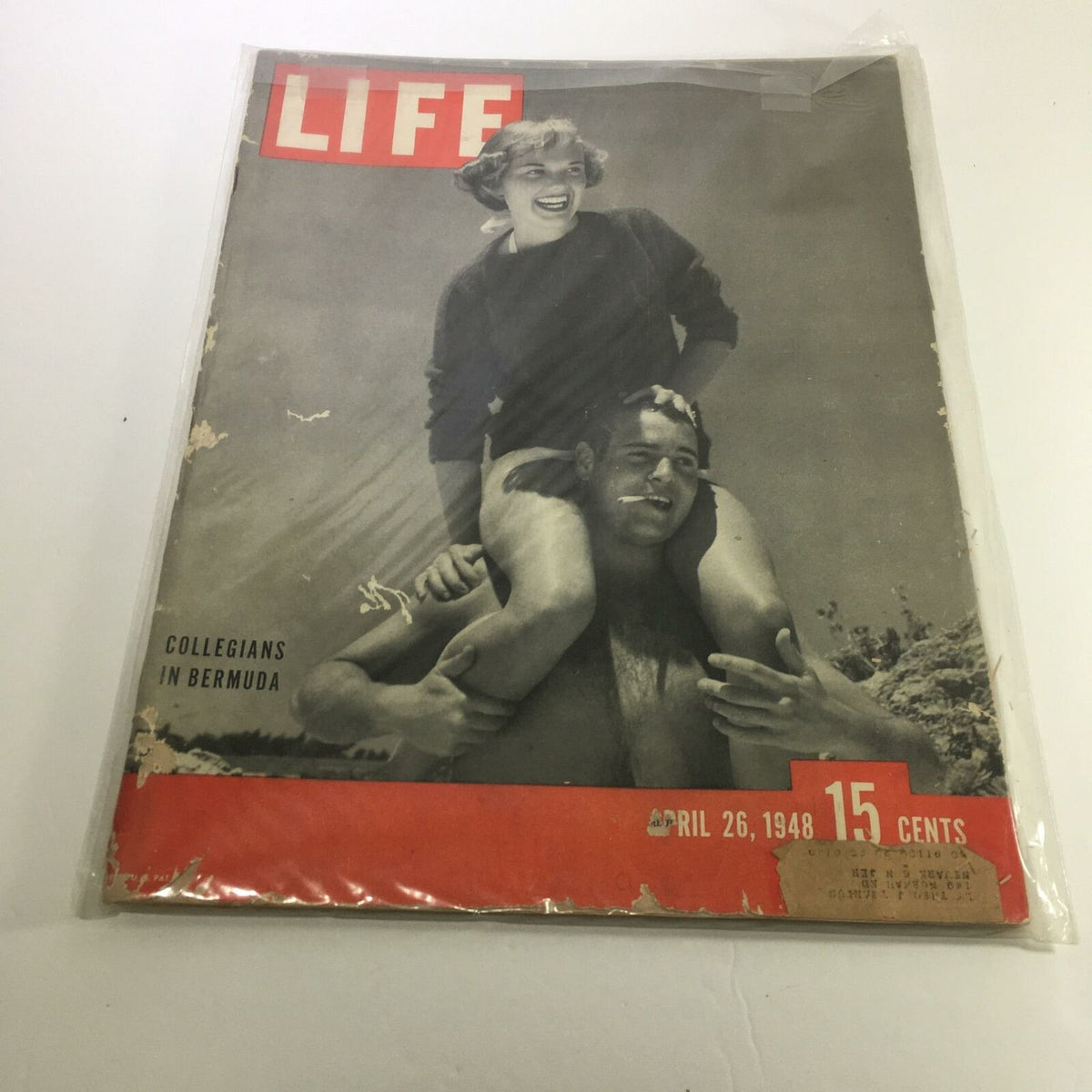 Cover of Life Magazine: April 26, 1948 - Collegians in Bermuda, featuring a vintage photograph of a young woman smiling while perched on a man's shoulders, highlighting the carefree spirit of collegiate life in Bermuda during the late 1940s.
