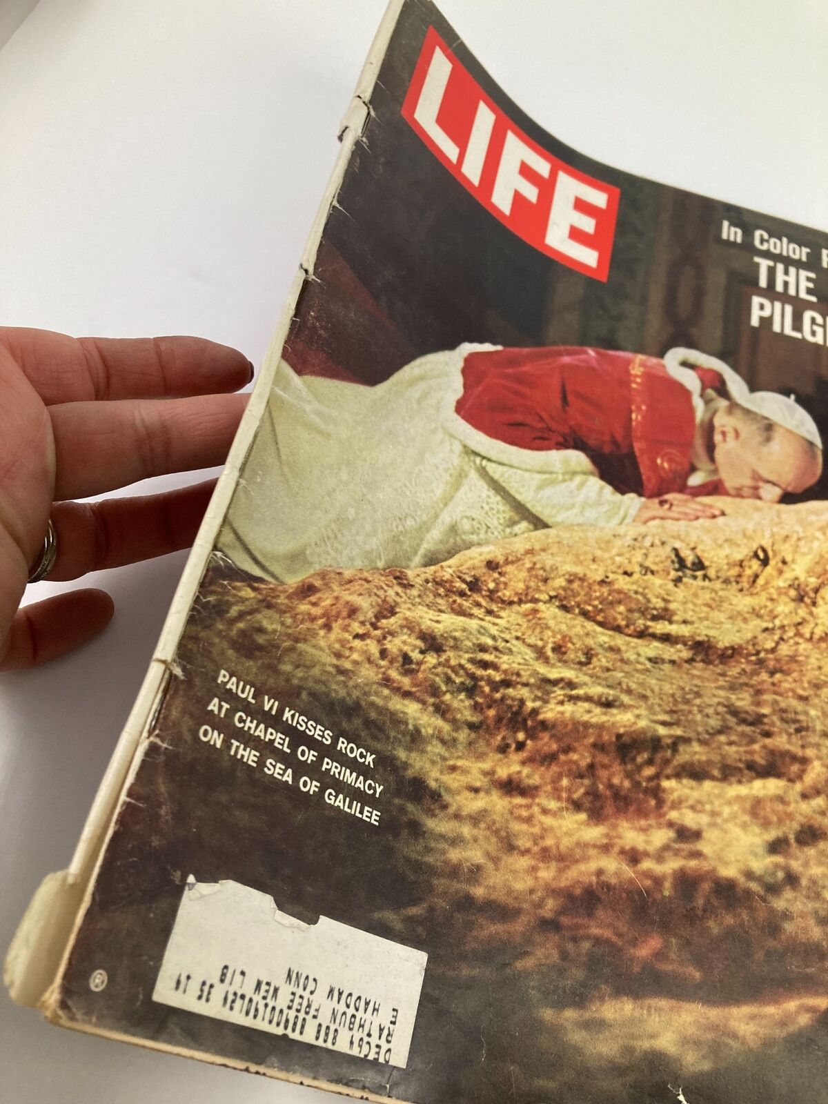 Side view of VTG Life Magazine January 17, 1964 displaying Pope Paul VI on the cover kissing a rock, with a visible address label and signs of age.