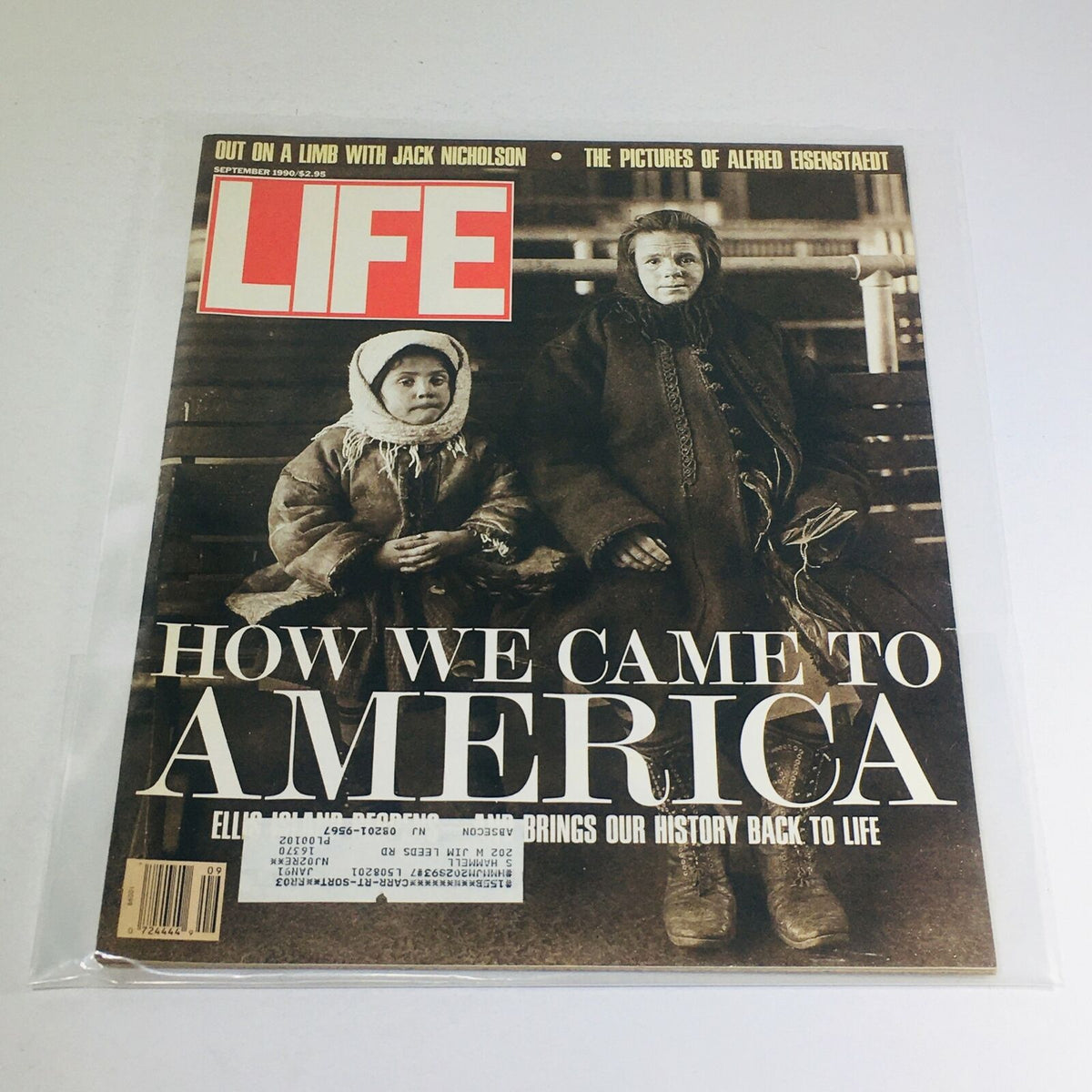 Cover of the vintage Life Magazine from September 1990 titled 'How We Came to America', featuring two young immigrants in traditional clothing reflecting the journey through Ellis Island.