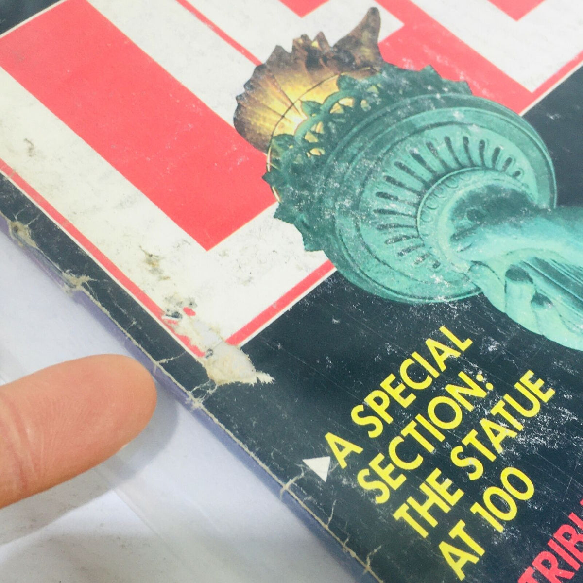Close-up of the cover of VTG Life Magazine from July 1986 showing wear and the Statue of Liberty with a special section indication about the statue's 100th anniversary.