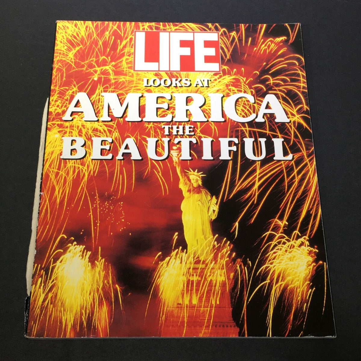 Cover of VTG Life Magazine 1990 titled 'Looks At America The Beautiful', featuring vibrant fireworks and the Statue of Liberty.