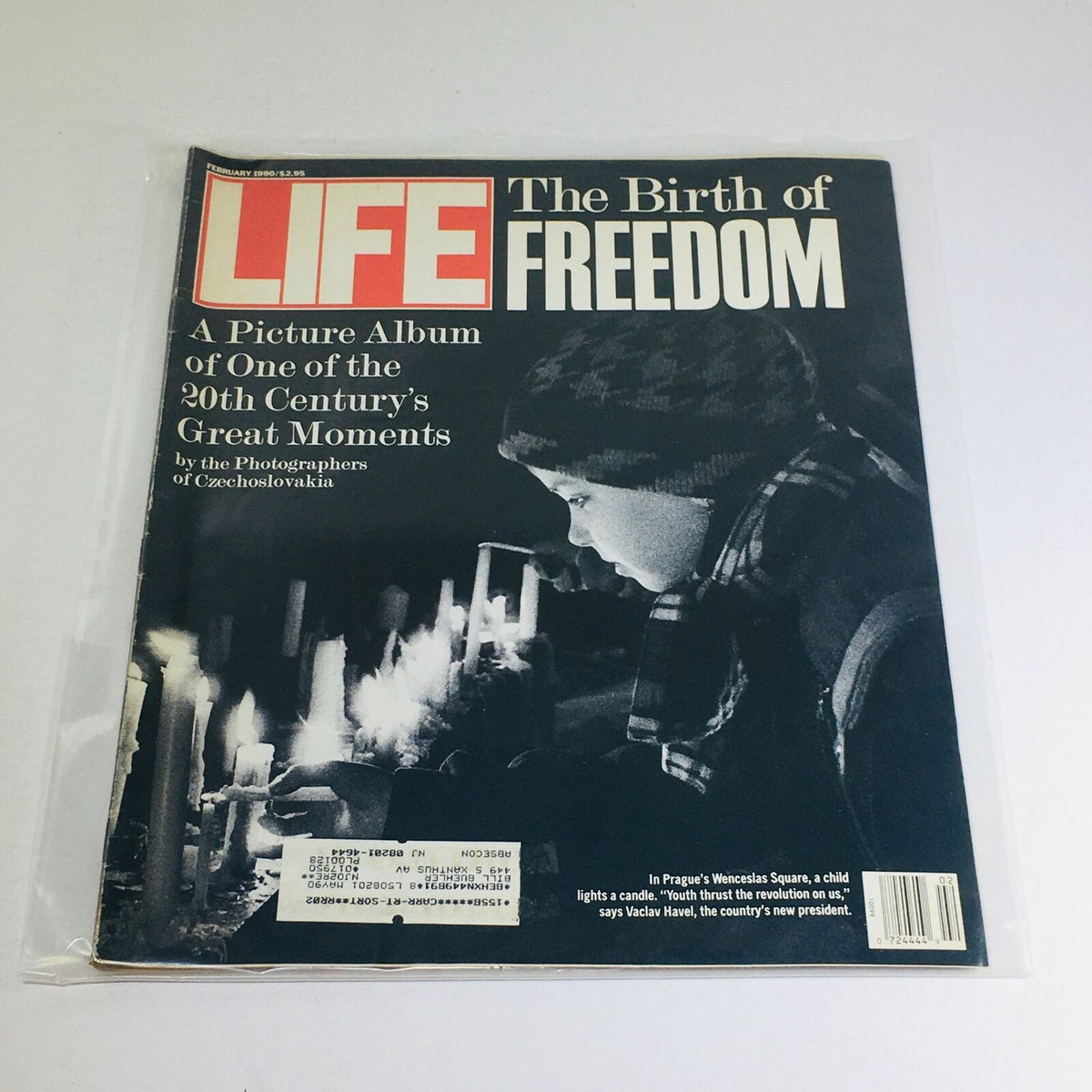 Cover of VTG Life Magazine from February 1990 featuring 'A Picture Album of One of the 20th Century's Great Moments'. The image shows a child lighting a candle, symbolizing hope and freedom, with a dramatic black and white design.
