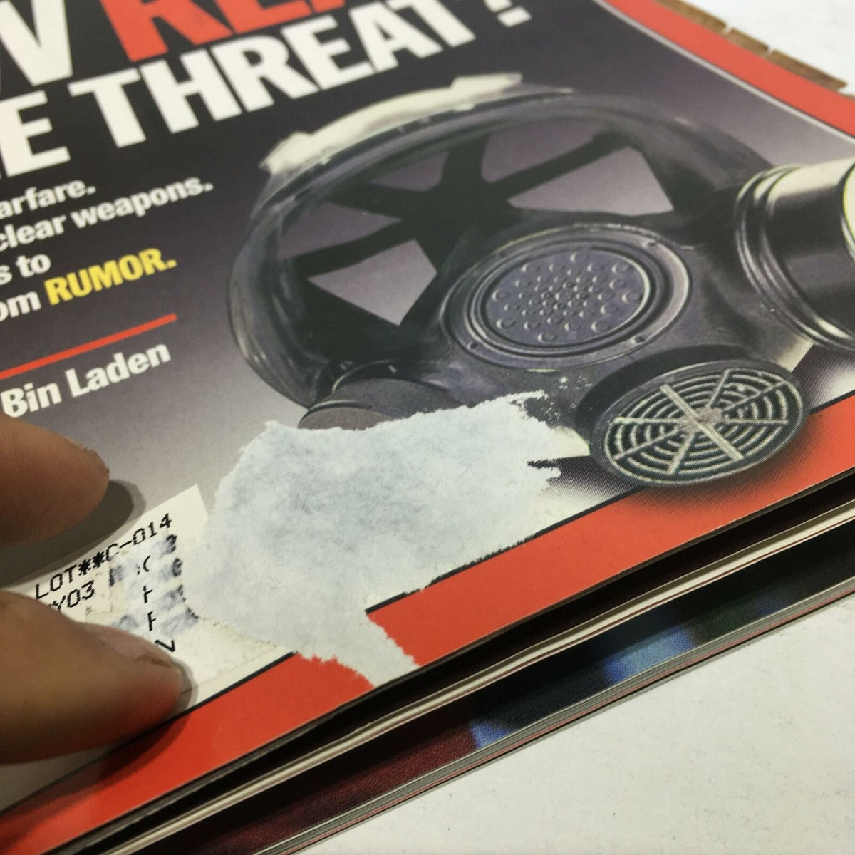 Damage detail on the cover of Time Magazine, Oct 8 2001 issue titled 'How Real Is The Threat? Germ & Chemical Warfare', featuring a gas mask, showcasing minor wear.