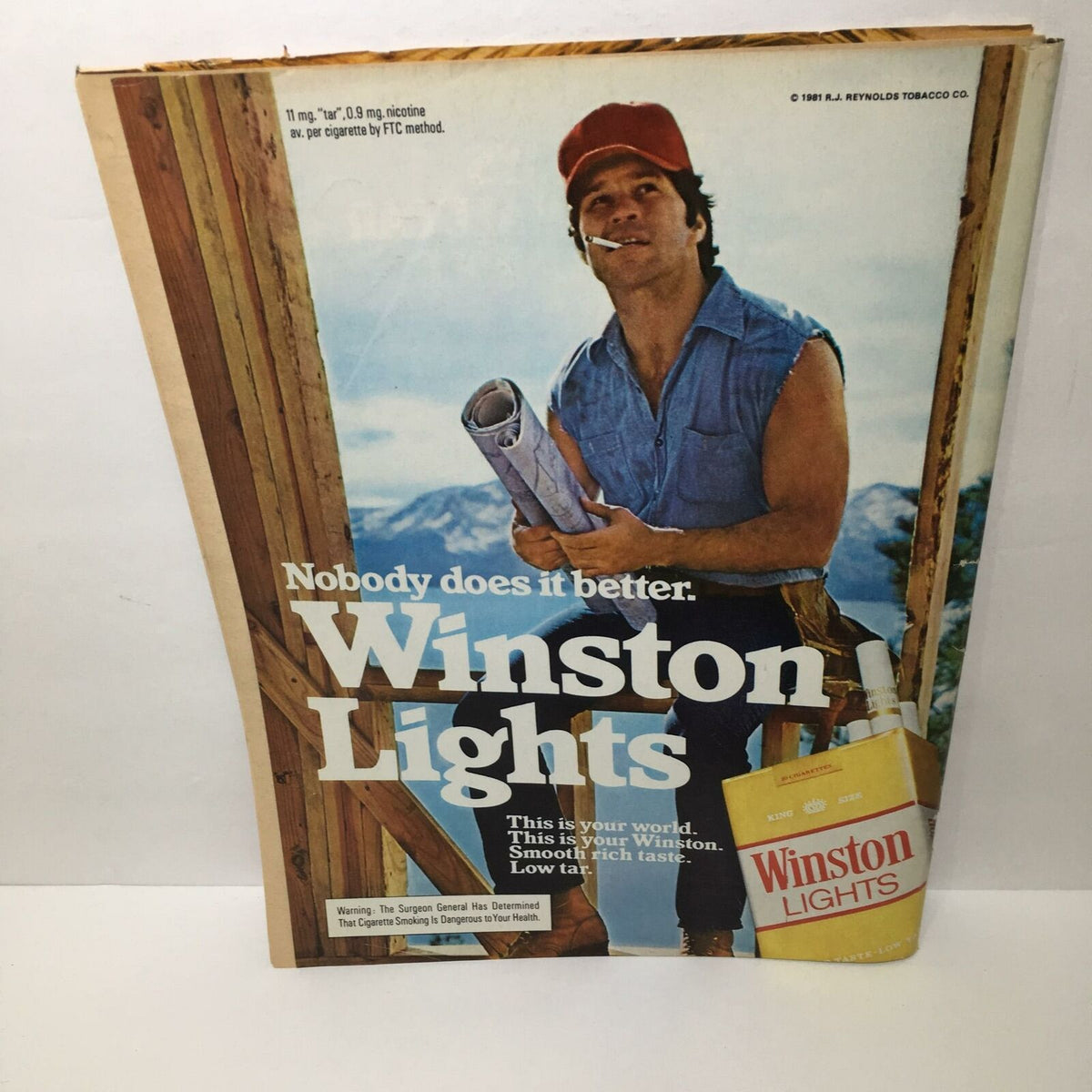 Vintage advertisement for Winston Lights cigarettes featuring a man in a red cap holding blueprints, reflecting the style of the early 1980s.