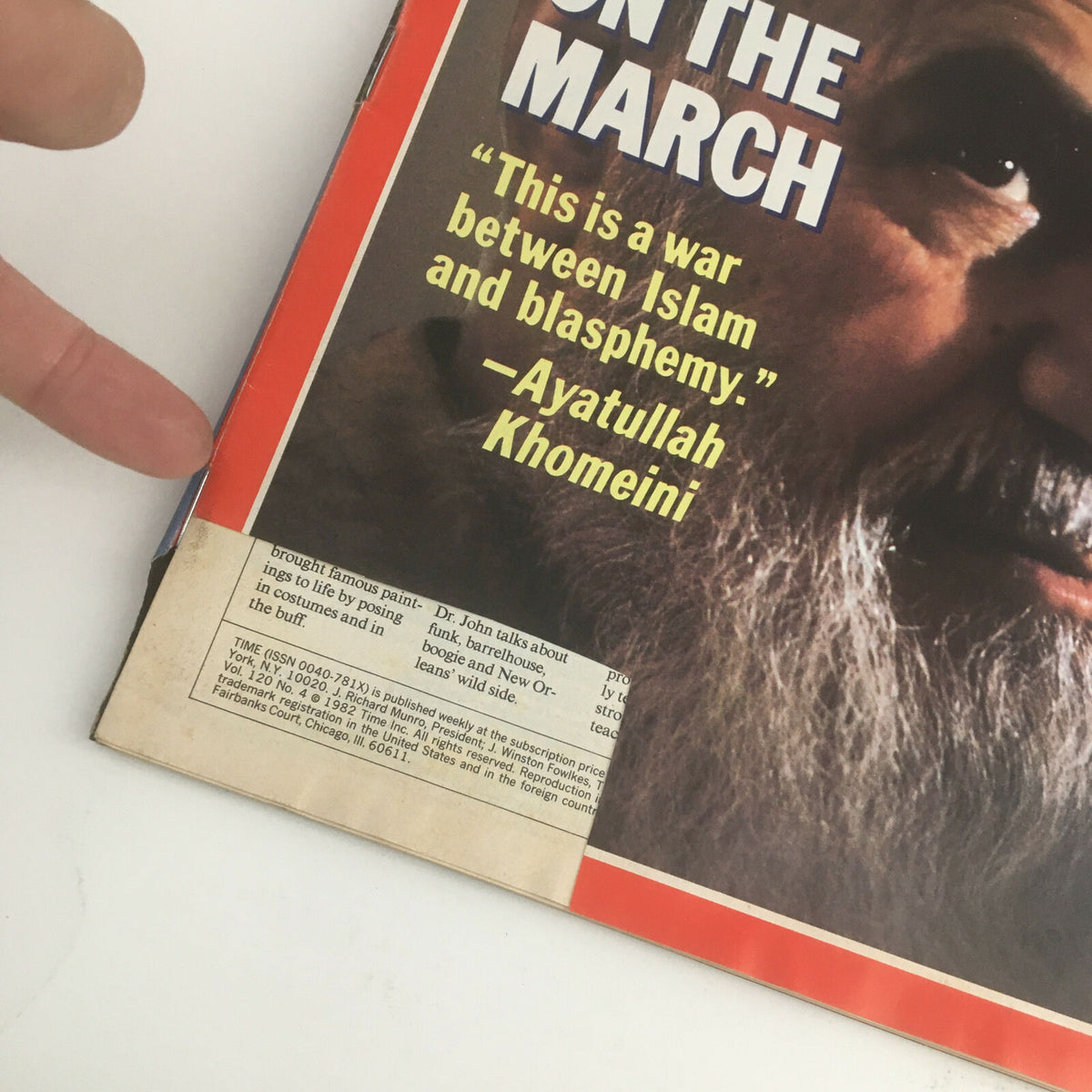 Close-up view of Time Magazine July 26 1982 cover highlighting Ayatollah Khomeini and the quote 'This is a war between Islam and blasphemy.' with a visible subscription detail at the bottom.