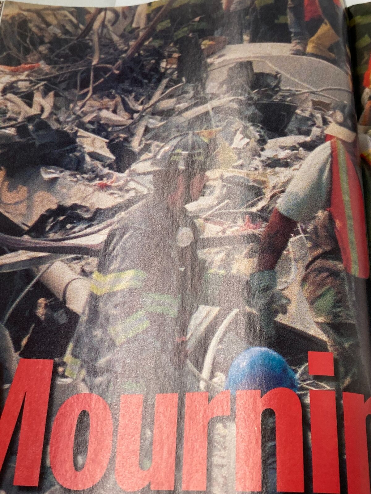 Image from Time Magazine September 24 2001 showing first responders mourning at the site of the World Trade Center collapse after the 9/11 tragedy.