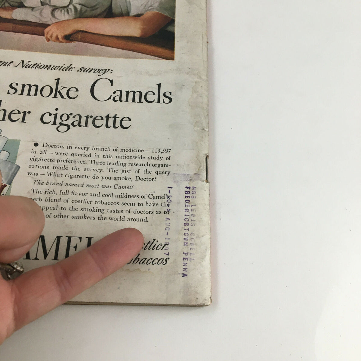 Time Magazine November 11 1946 cover detail showing an advertisement for Camel cigarettes alongside a finger pointing at the text, highlighting historical marketing practices.