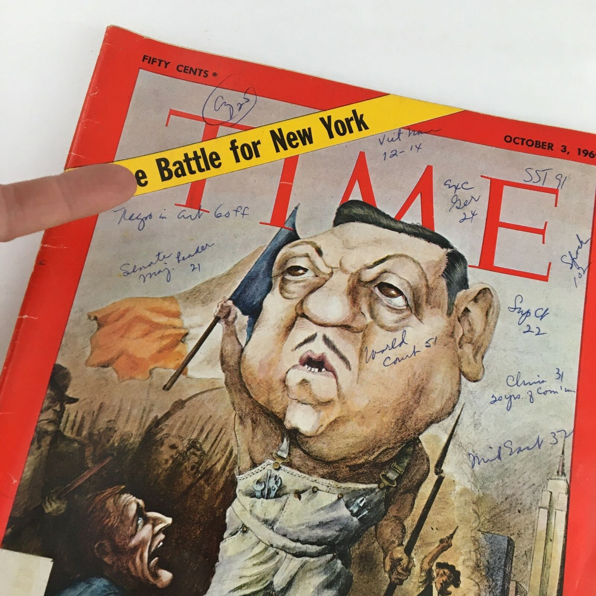 Close-up view of the Time Magazine cover from October 3, 1969, showing the title 'The Battle for New York' and caricature of Mario Procaccino with handwritten notes above. The image reflects the magazine's historical significance.
