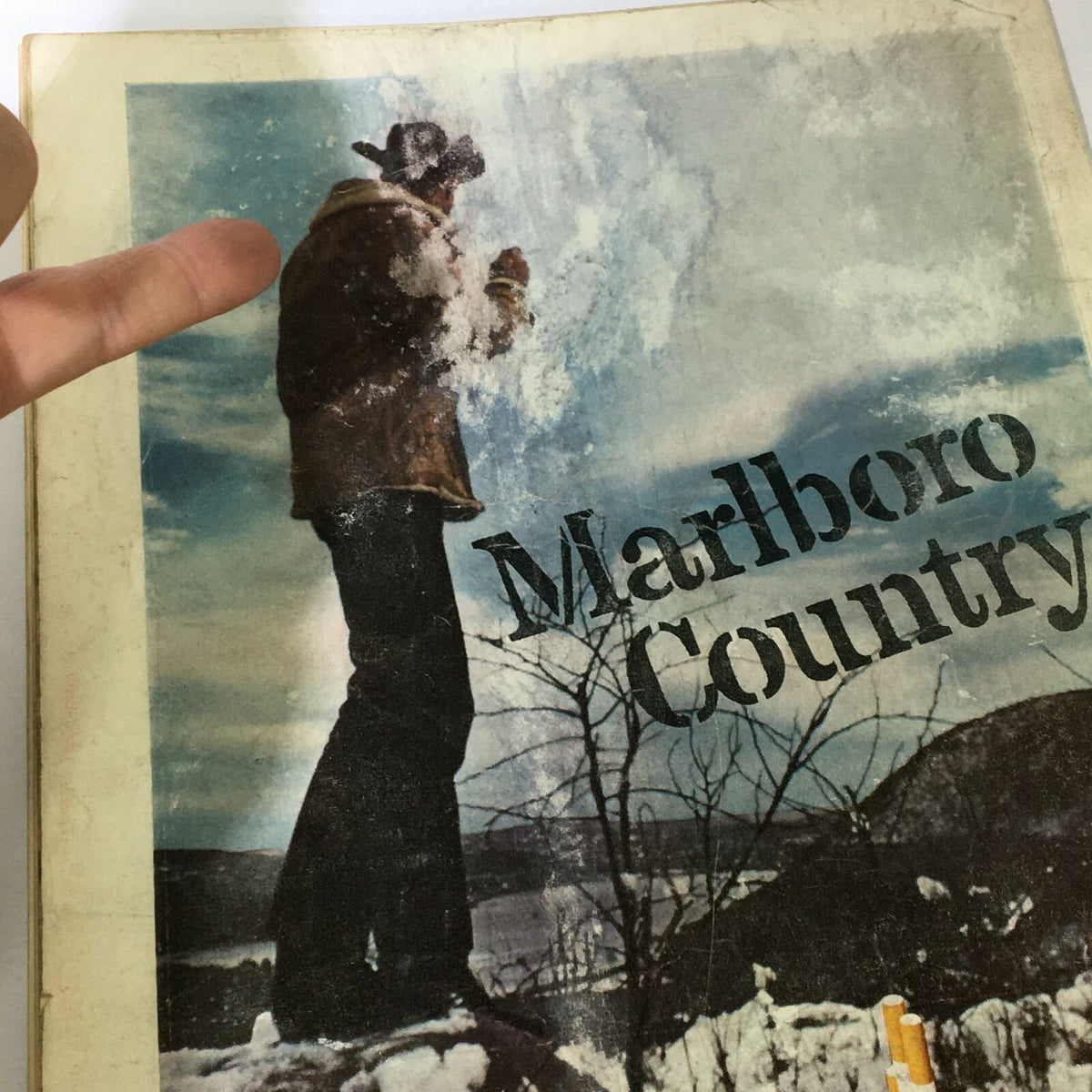 Back cover of the VTG Time Magazine from March 1, 1963, depicting a scene from Marlboro Country. The image captures a figure in nature against a scenic backdrop, emphasizing the nostalgic feel of the magazine.