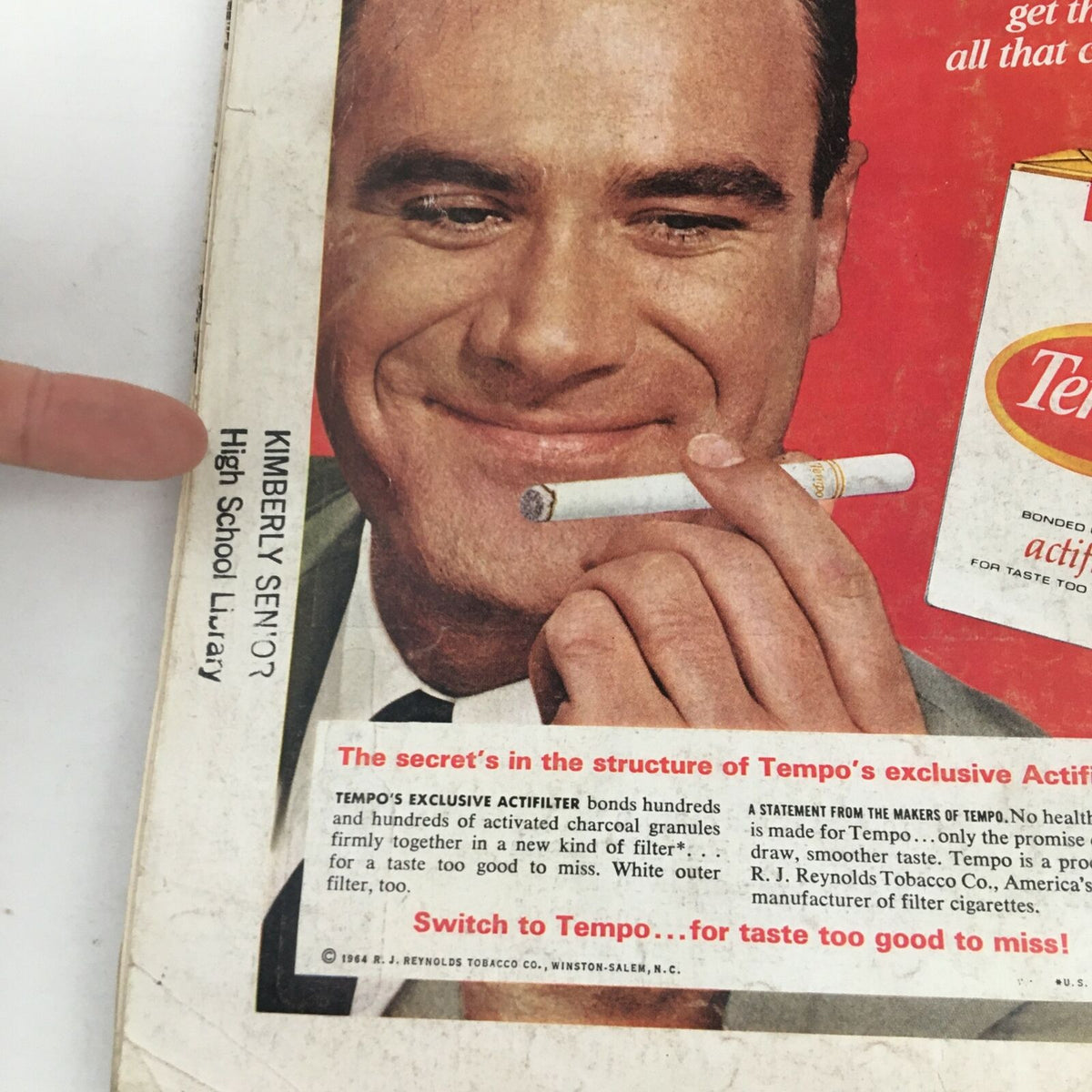 Close-up of a vintage advertisement from Time Magazine October 16, 1964 featuring a smiling man holding a cigarette with a product label for Tempo cigarettes, showcasing mid-20th century marketing.