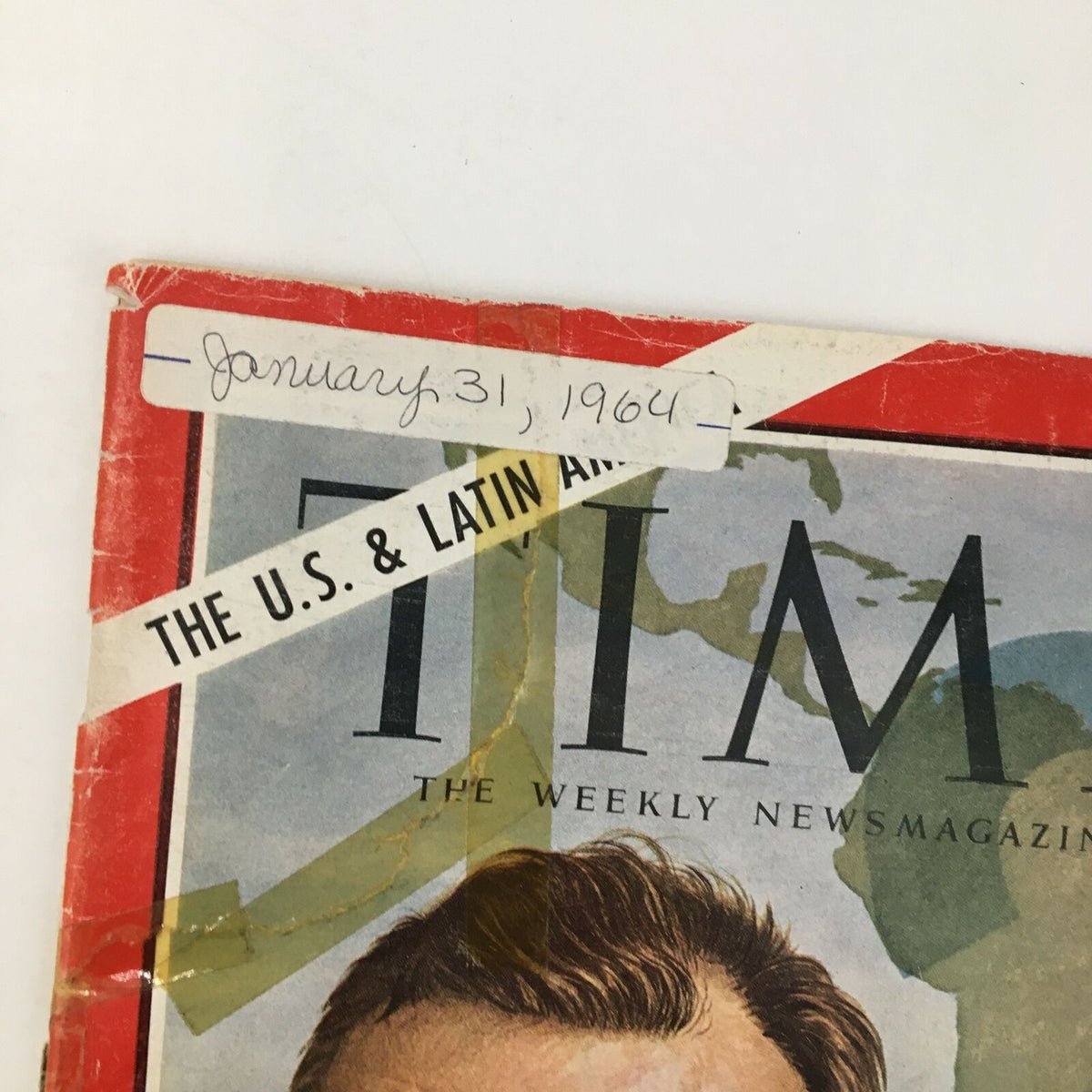Close-up of the top left corner of Time Magazine January 31, 1964, showing a handwritten date and additional details on the vintage cover.