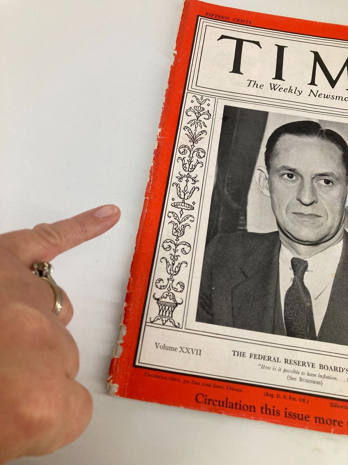 Vintage Time Magazine February 10, 1936, showcasing the Federal Reserve Board article, with a close-up of the magazine cover and a hand pointing at it.