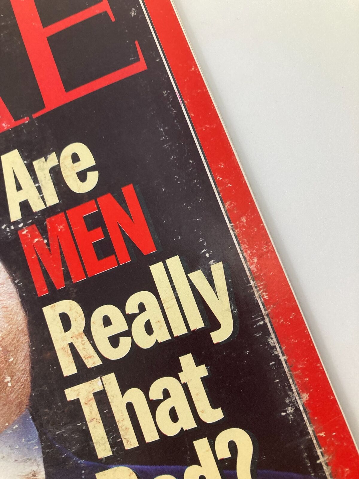 Detail of the Time Magazine cover from February 14, 1994, focusing on the title 'Are MEN Really That Bad?' showcasing bold typography and artistic design.