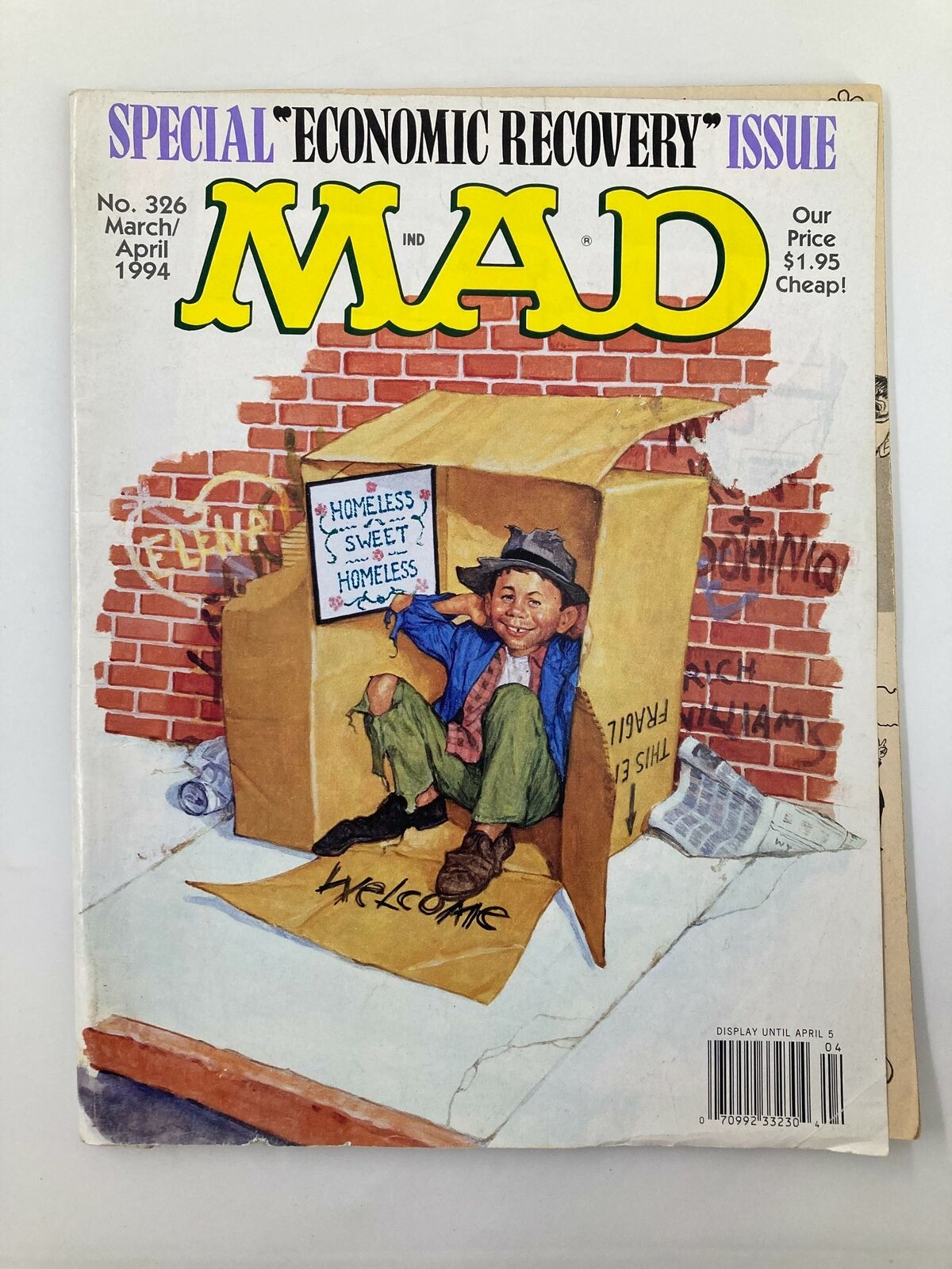 Cover of Mad Magazine March 1994 Issue #326 featuring Alfred E. Neuman illustrated as a homeless man with a sign that reads 'Homeless Sweet Homeless', highlighting economic themes.