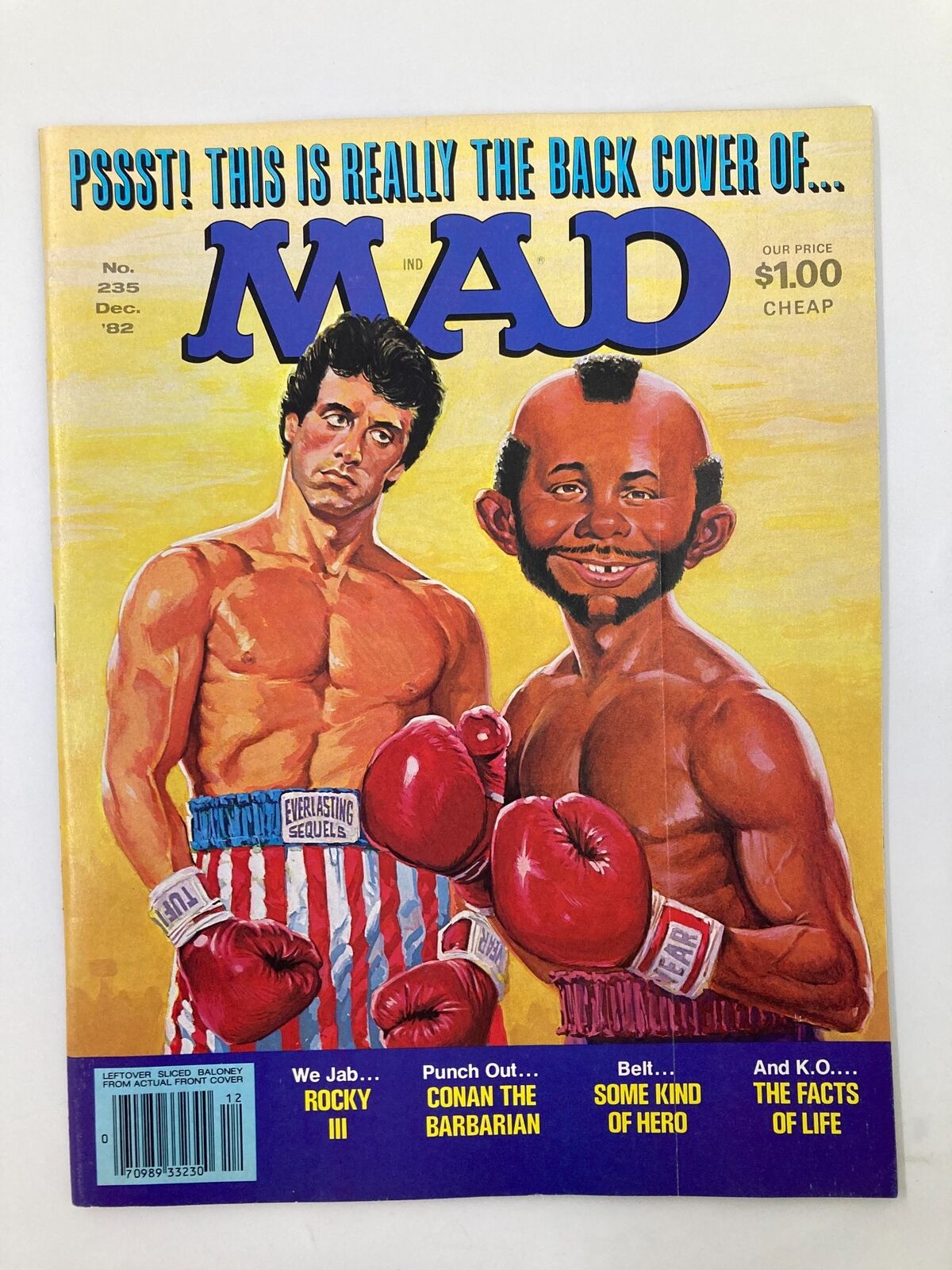 Mad Magazine December 1982 No. 235 featuring Rocky and Conan on the cover. The cover showcases stylized illustrations with Rocky in boxing gloves and Conan, creating a comedic and satirical representation of the era's pop culture, rated Very Fine 8.0.