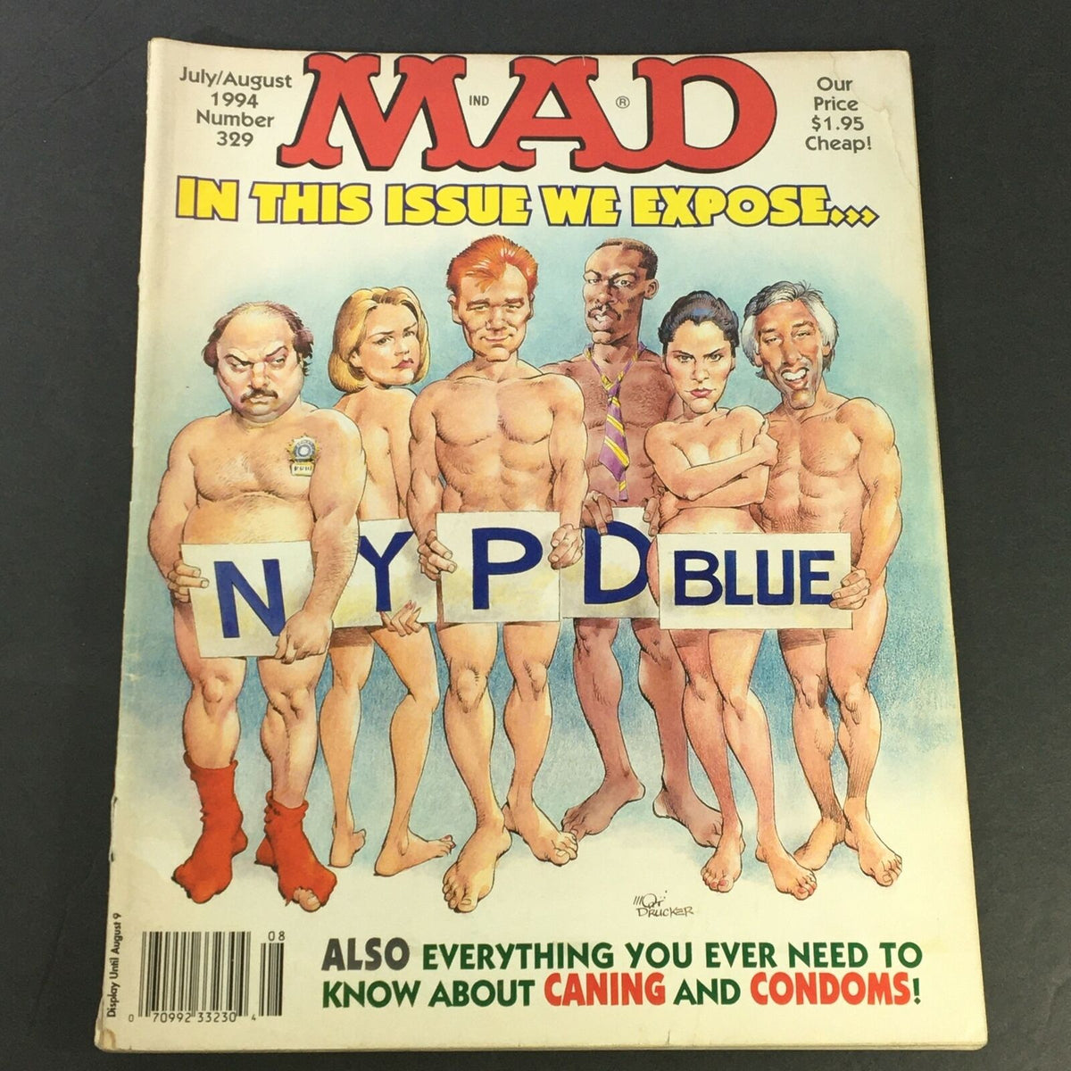 Cover of Mad #329, July August 1994, featuring a humorous depiction of individuals representing the New York Police Department Blue, along with a thematic reference to caning and condoms.