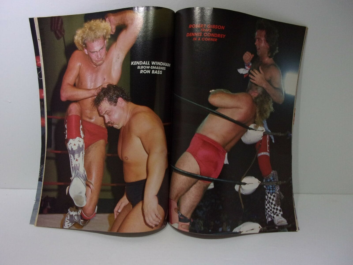 Image from Wrestling Action Magazine: June 1987 featuring Kendall Windham delivering an elbow smash to Ron Bass during a wrestling match, showcasing a moment of action from the magazine.