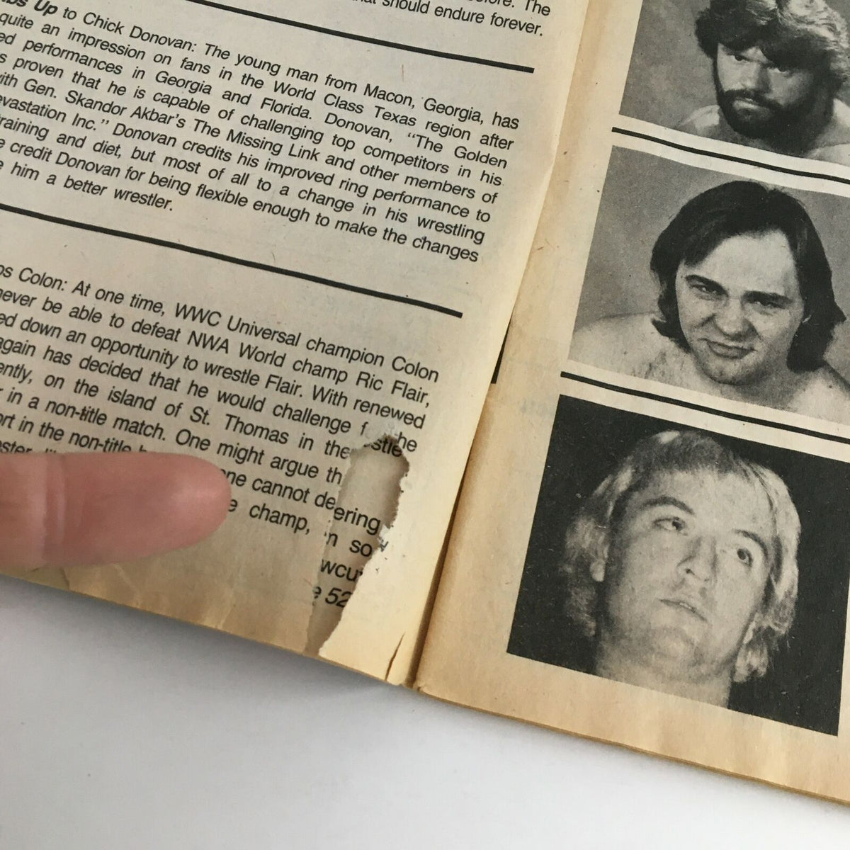 Close-up of a page from The Wrestler Magazine August 1984, highlighting a damaged area on the edge, showcasing vintage wrestling content related to Chick Donovan.
