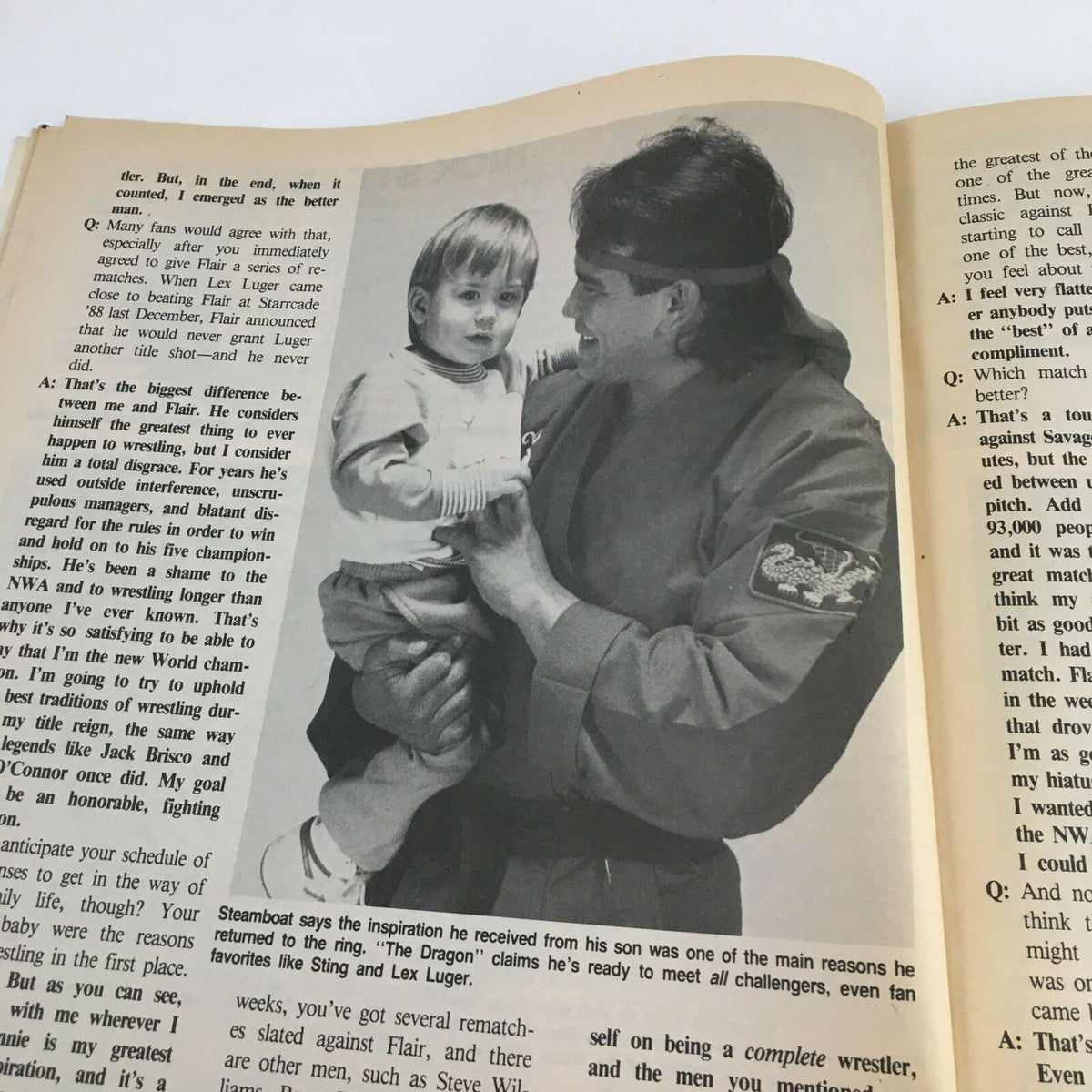 Black and white photograph from The Wrestler Magazine June 1989, featuring Rick Steamboat holding a child, discussing his inspiration from family amidst wrestling stories and interviews.