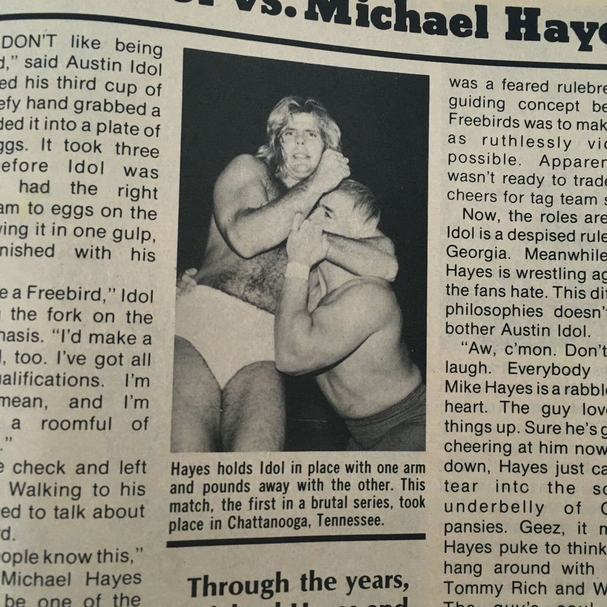 Black and white photo from Sports Review Wrestling Magazine April 1982 showing Austin Idol in a wrestling hold against Michael Hayes during a match, capturing the intensity of 1980s professional wrestling.
