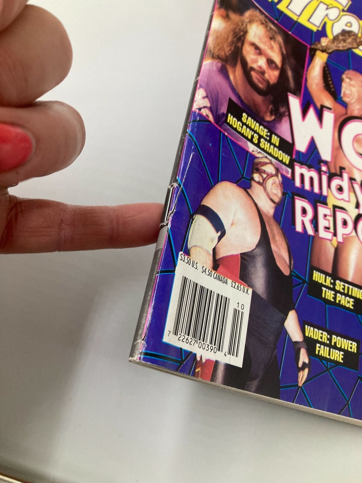 Close-up of the spine of Inside Wrestling Magazine October 1995, showing the wear on the binding and part of the cover image featuring Randy Savage and Hulk Hogan.