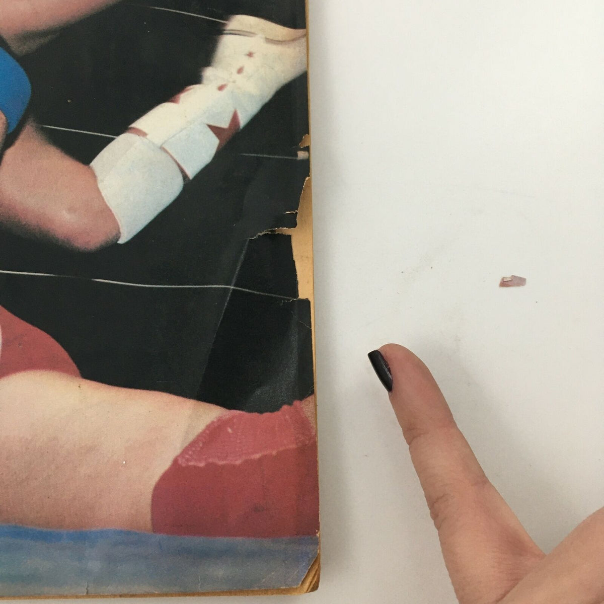 Close-up image showing wear on the edge of the Wrestling Album #4 magazine, highlighting the vintage condition described.