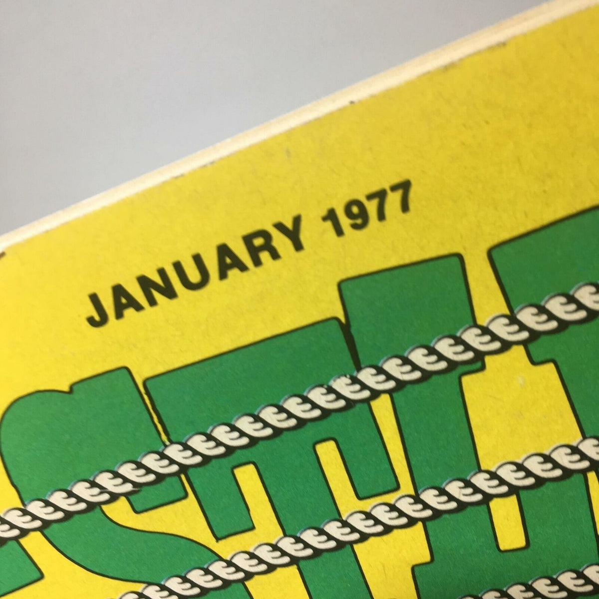 The Big Book of Wrestling January 1977 cover showing the top edge with 'JANUARY 1977' text on a bright yellow background.