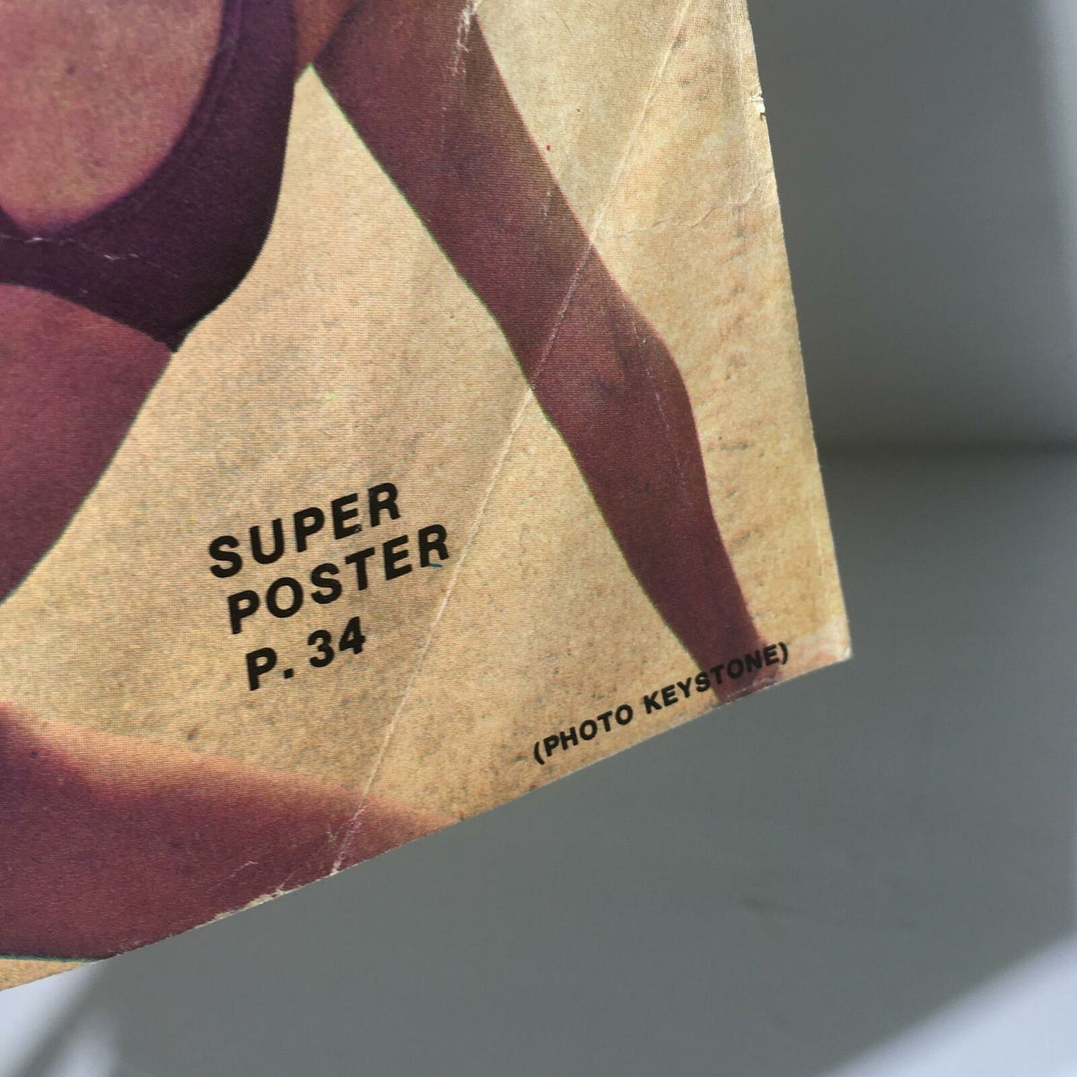 The Big Book of Wrestling January 1977 featuring a page corner with 'SUPER POSTER P. 34' and an image of a female athlete.