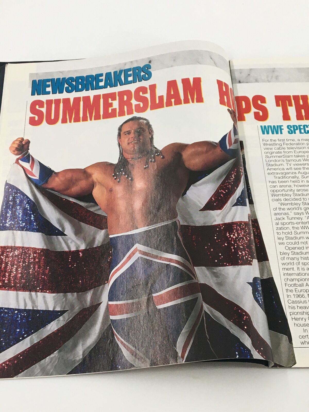 WWF Magazine August 1992 Newsbreakers article showing a wrestler proudly displaying the British flag in a vibrant outfit.