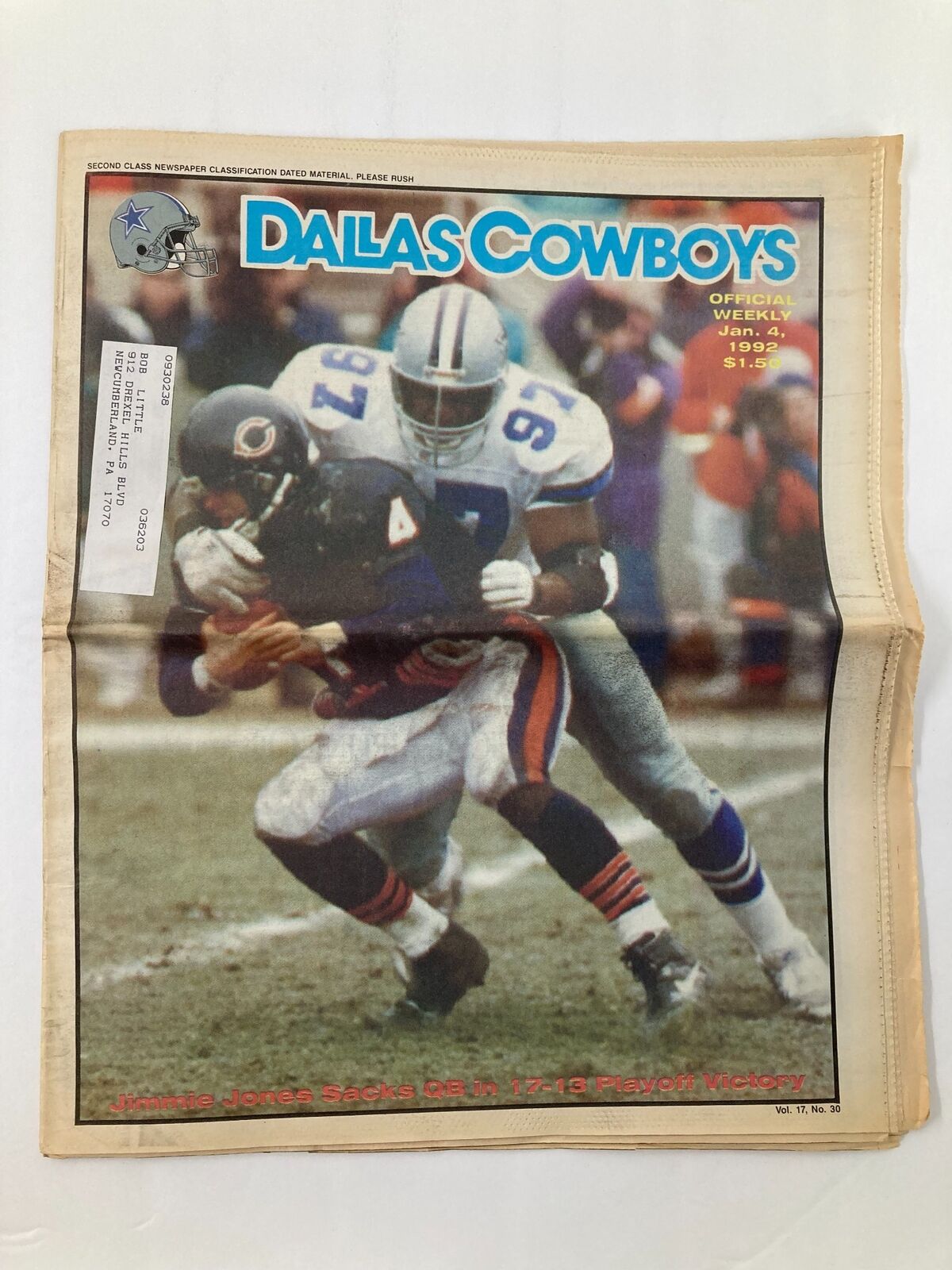 Dallas Cowboys Weekly Newspaper January 4 1992 Vol 17 #30 featuring Jimmie Jones tackling an opposing player during a playoff game. This image captures a historic moment in Dallas Cowboys football.