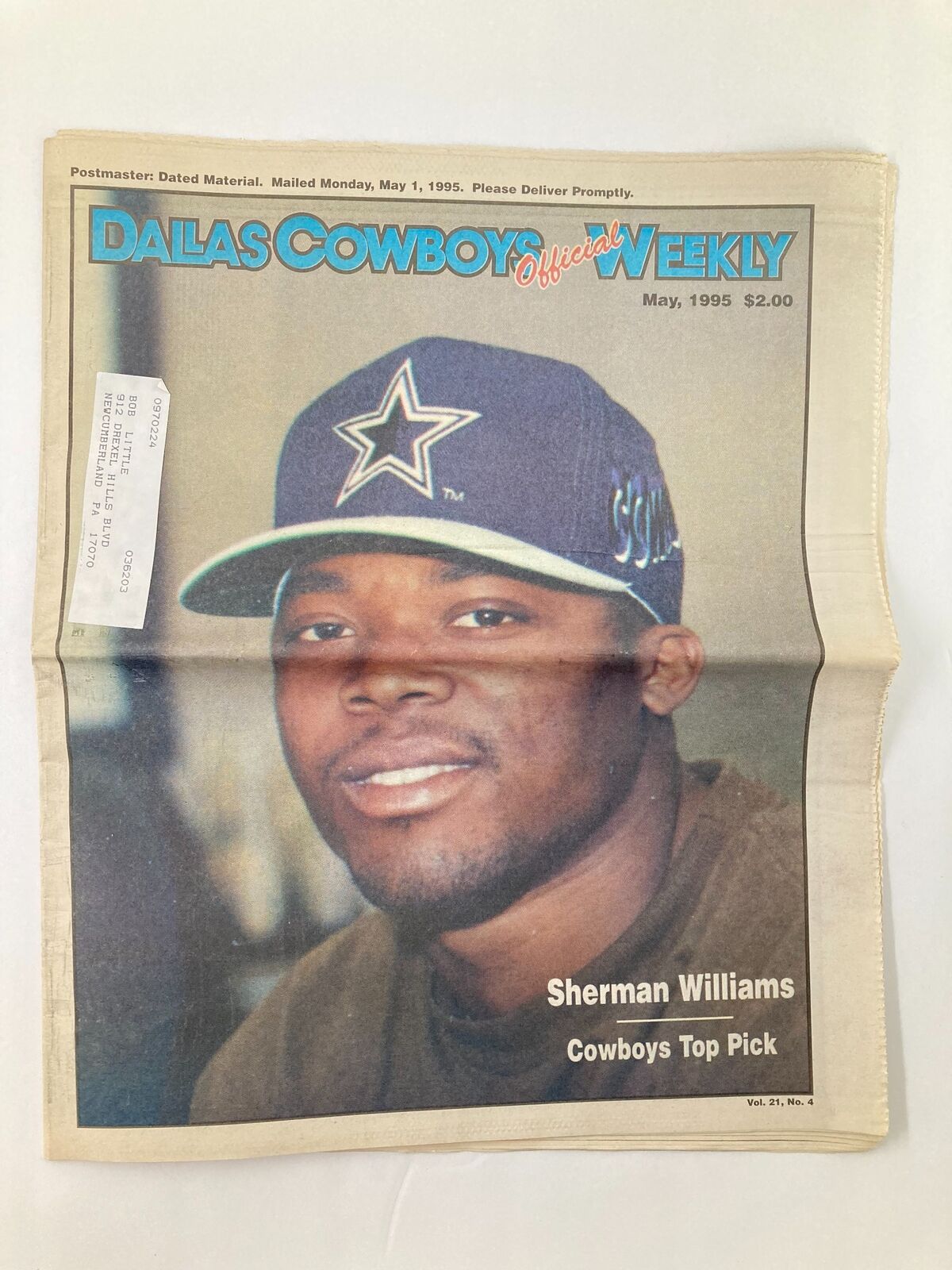 Cover of Dallas Cowboys Weekly Newspaper from May 1995 featuring Sherman Williams, who is highlighted as the Cowboys' top pick, under the headline 'Dallas Cowboys Official Weekly'. The newspaper showcases a photo of Sherman Williams wearing a Cowboys cap.