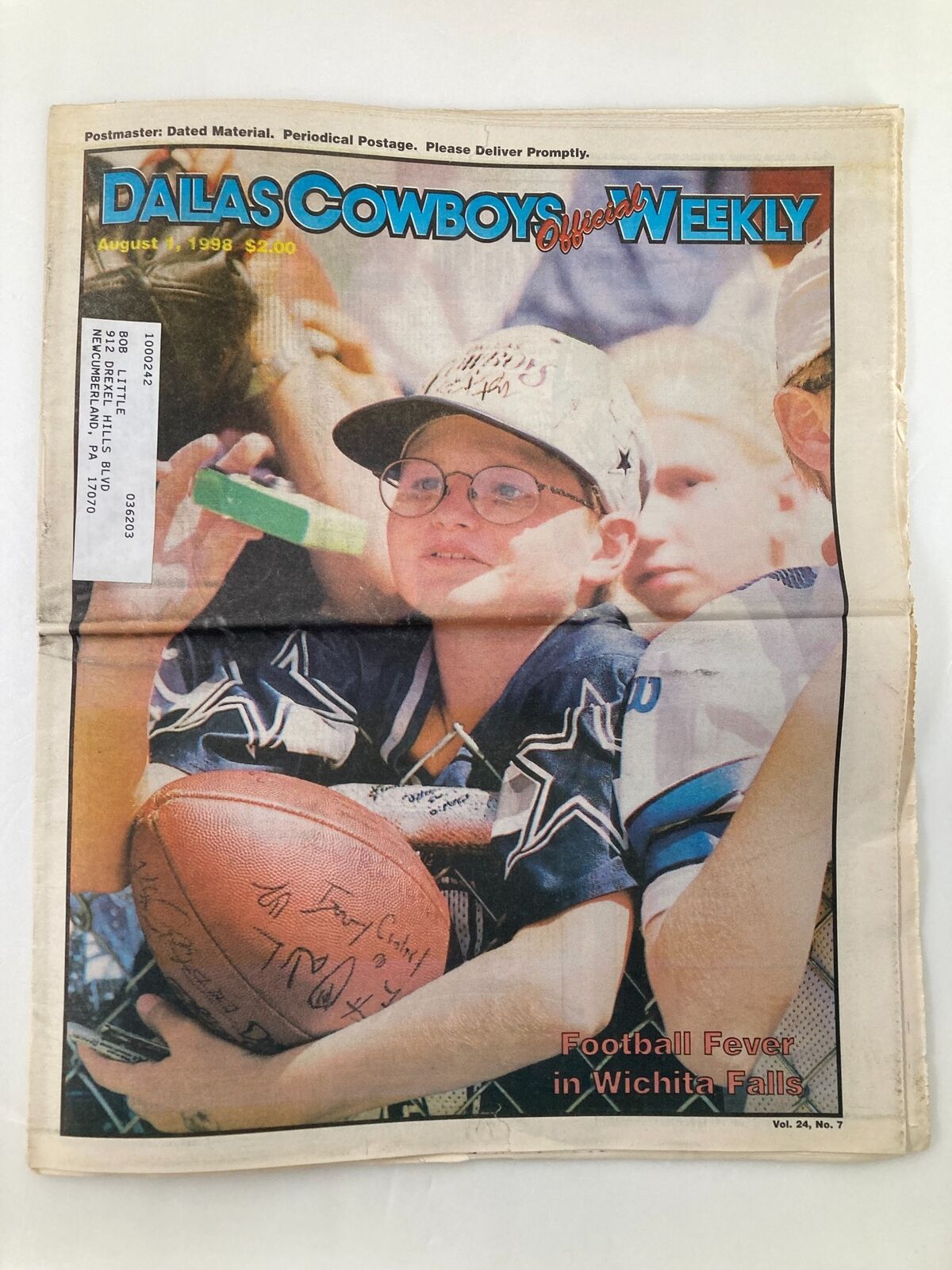 Dallas Cowboys Weekly Newspaper August 1 1998 Vol 24 #7 cover featuring a young fan with a signed football, highlighting the excitement of the team and football culture.
