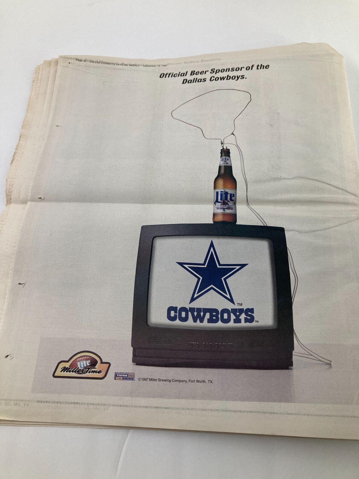 Official advertisement featuring a vintage television showcasing the Dallas Cowboys logo and a beer, highlighting the Dallas Cowboys Weekly Newspaper September 13, 1997, Vol 23 #14 featuring Emmitt Smith.