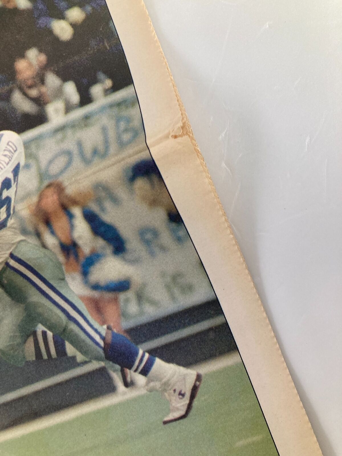 Close-up view of the Dallas Cowboys Weekly Newspaper December 31 1992 showing minor wear and tear, emphasizing its vintage condition.