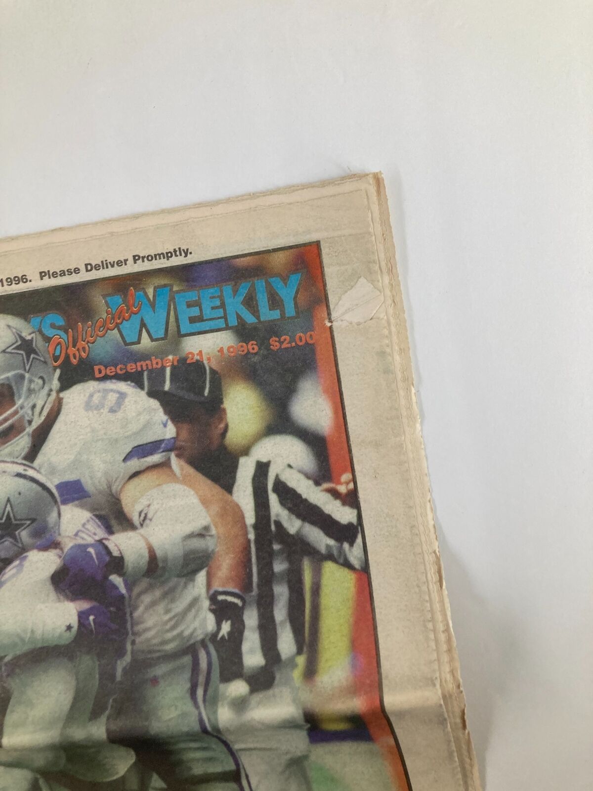 Close-up view of the Dallas Cowboys Weekly Newspaper December 21 1996 Vol 22 #28 revealing minor wear and a label on the front, highlighting the historical significance of the publication.