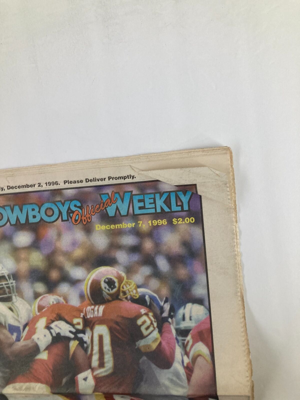 Close-up of the Dallas Cowboys Weekly Newspaper December 7, 1996, showing the front cover with $2.00 price tag and publication date.