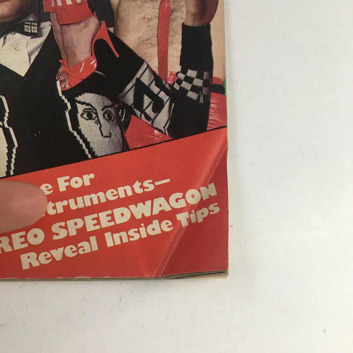 Close-up of the bottom corner of Circus Magazine December 31 1980, showing a bright red section with the title 'REO Speedwagon Reveal Inside Tips' alongside artwork.