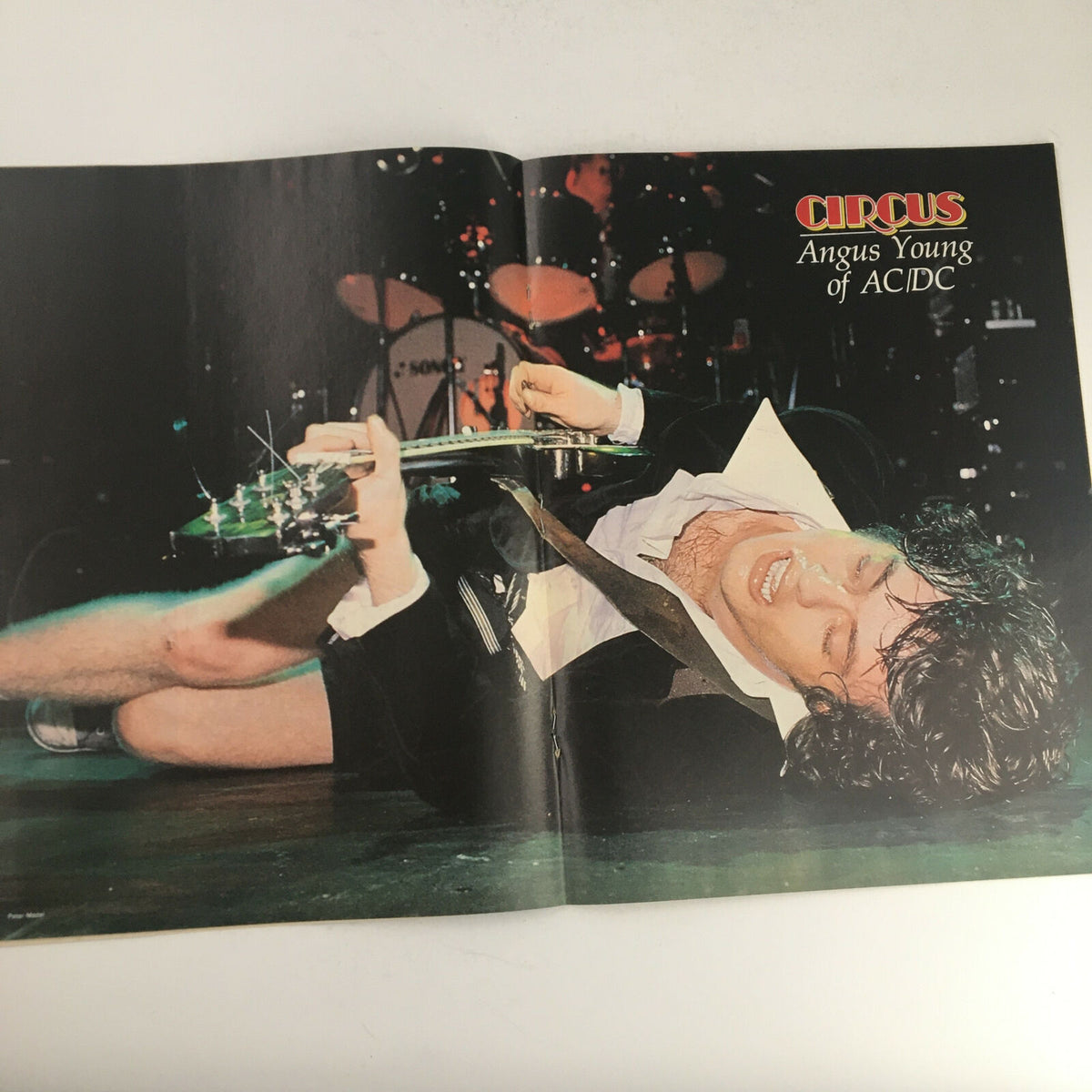 Poster from Circus Magazine January 16, 1979 showcasing Angus Young of AC/DC performing passionately on stage, representing the vibrant rock scene of the late 1970s.