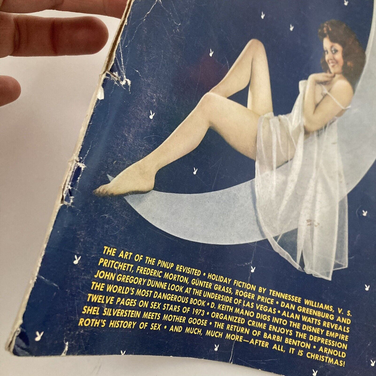 Close-up view of the corner of the Vintage Playboy Magazine December 1973 cover, showcasing the text and details of the publication.