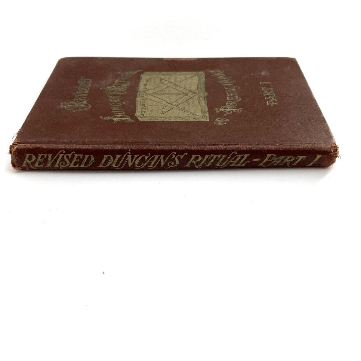 1922 DUNCAN'S RITUAL AND MONITOR OF FREEMASONRY Part 1 book cover featuring a decorative design and title embossed in gold on a brown background.
