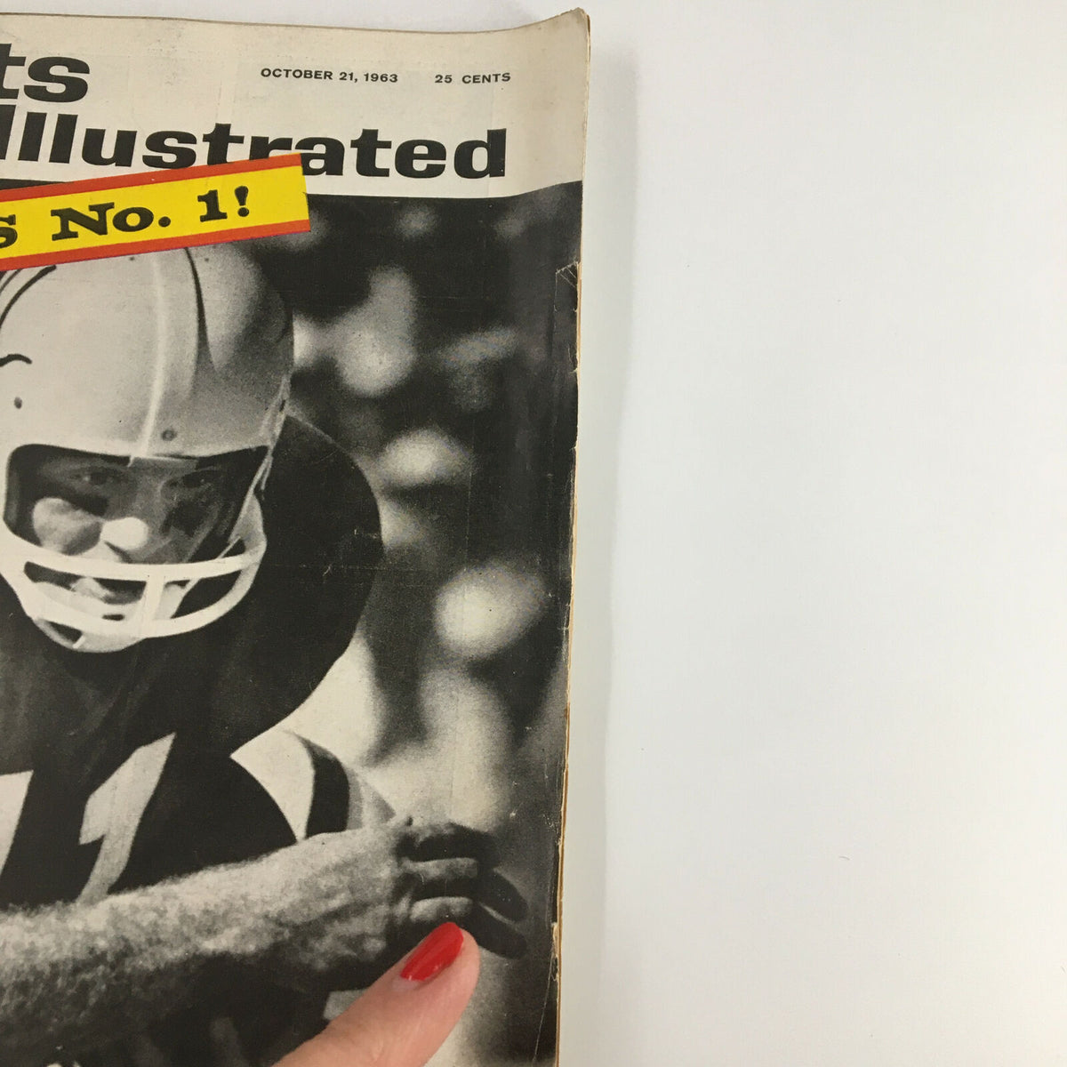 Close-up view of the vintage Sports Illustrated Magazine cover dated October 21, 1963 showing Duke Carlisle during a game against Oklahoma.