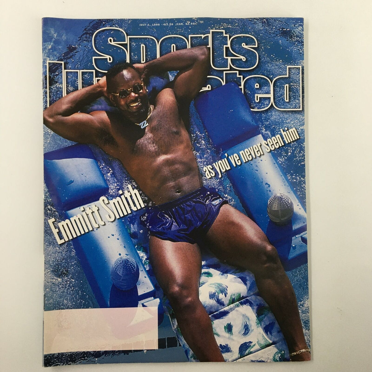 Cover of Sports Illustrated Magazine from July 1, 1996, featuring Emmitt Smith relaxing on a pool float, highlighting his playful side as a celebrated football star.