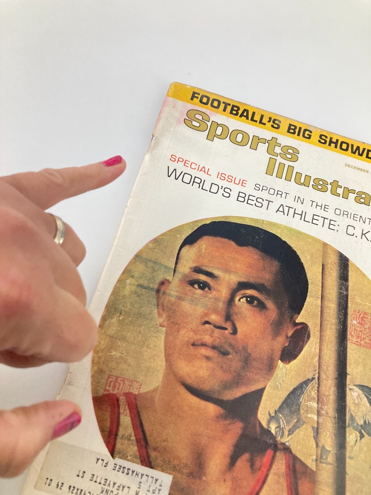 Close-up view of the VTG Sports Illustrated Magazine December 23 1963 cover featuring C.K. Yang, World's Best Athlete, highlighting the detail of the magazine's iconic design and authenticity.