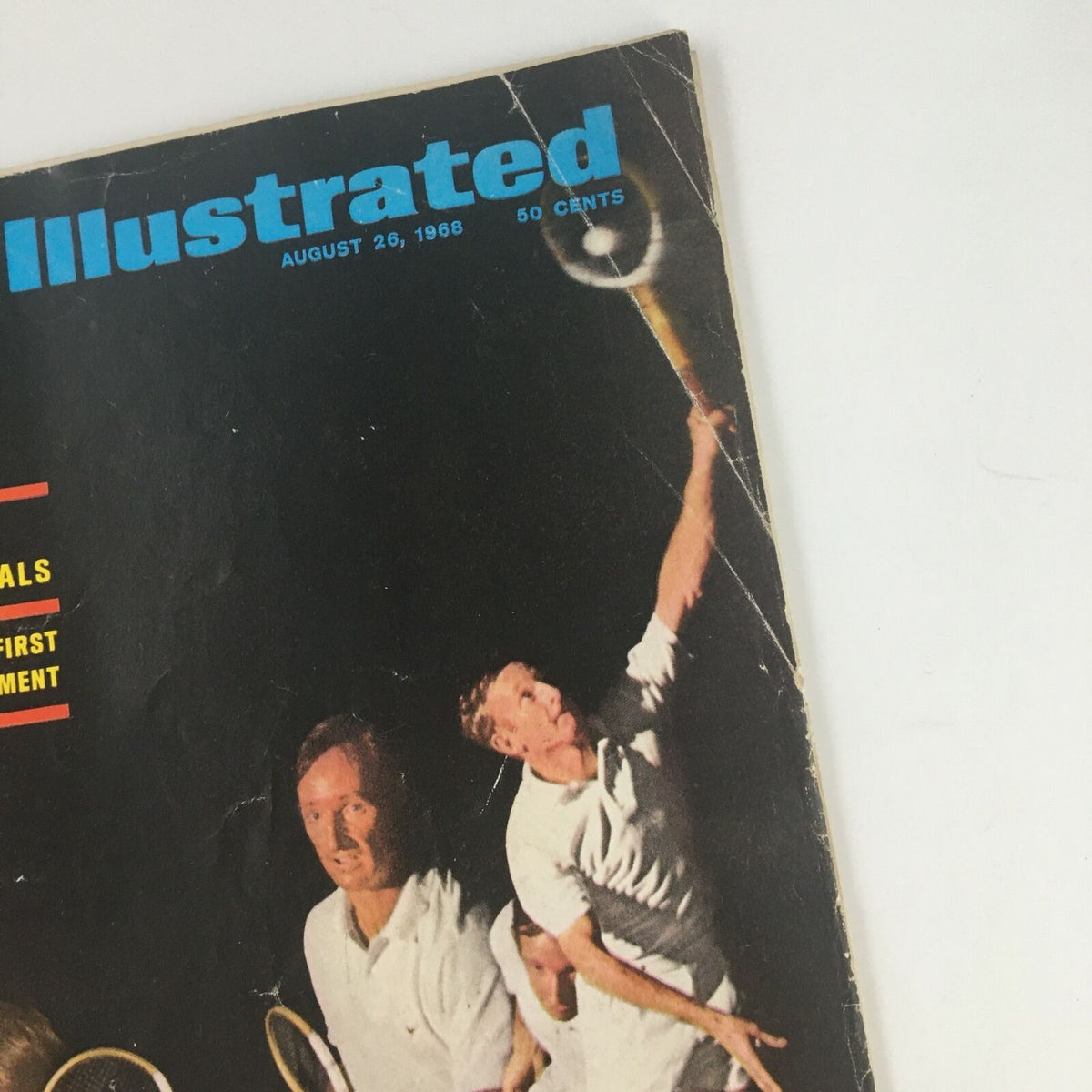 Detail of the Sports Illustrated Magazine cover from August 26 1968, focusing on Rod Laver performing a tennis serve, with visible wear on the cover.