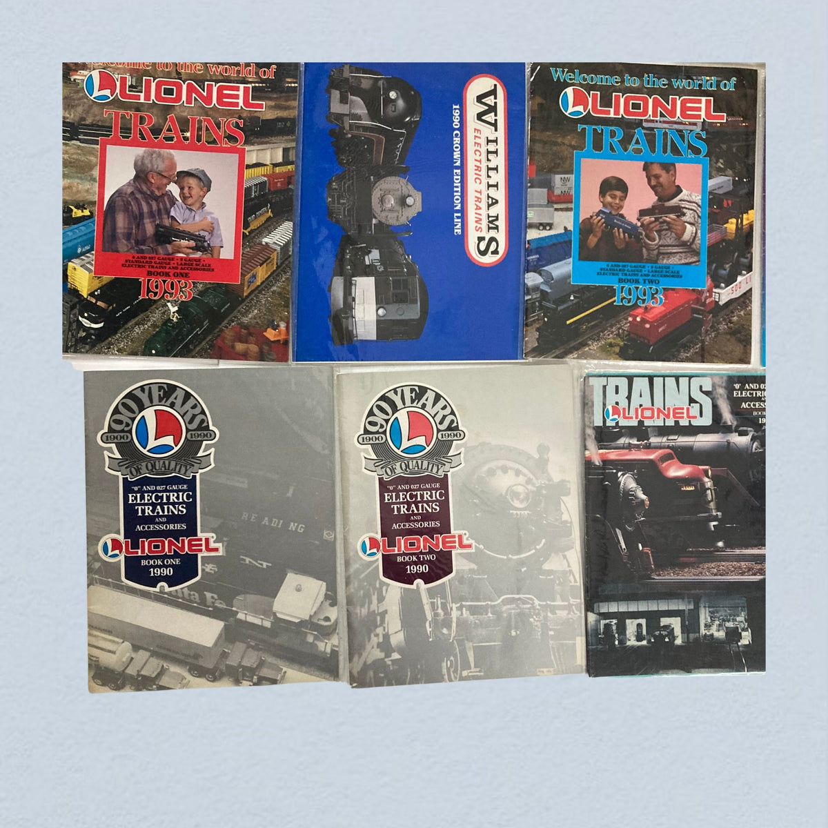 Lot of 24 1990s Lionel Electric Trains and Accessories Catalog, including detailed covers of Lionel trains catalogs from 1990, highlighting train models, accessories, and promotional content.