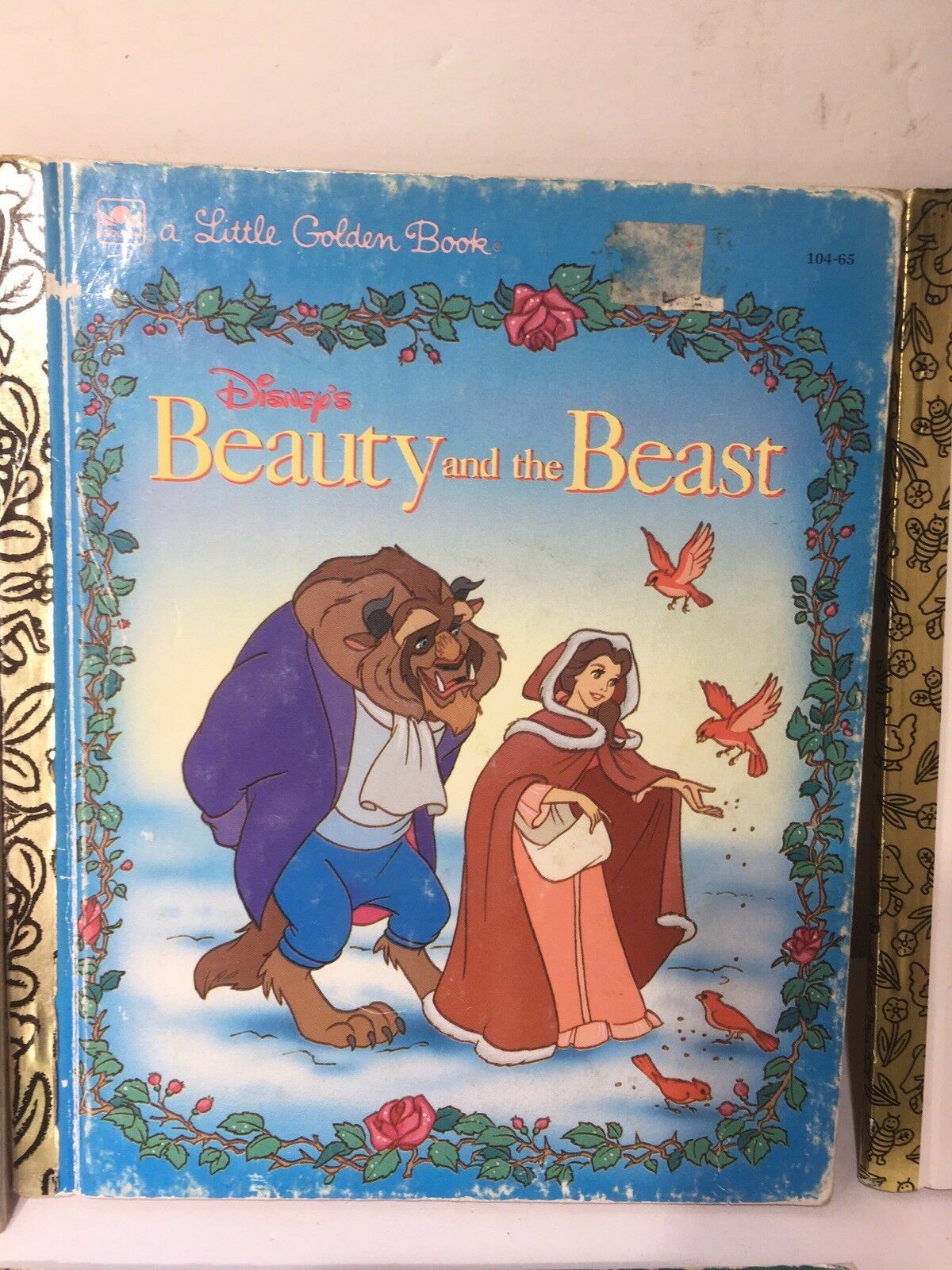 Little Golden Book Disney Beauty and the Beast displaying a scene with Belle and the Beast surrounded by birds, capturing the essence of this classic fairy tale.