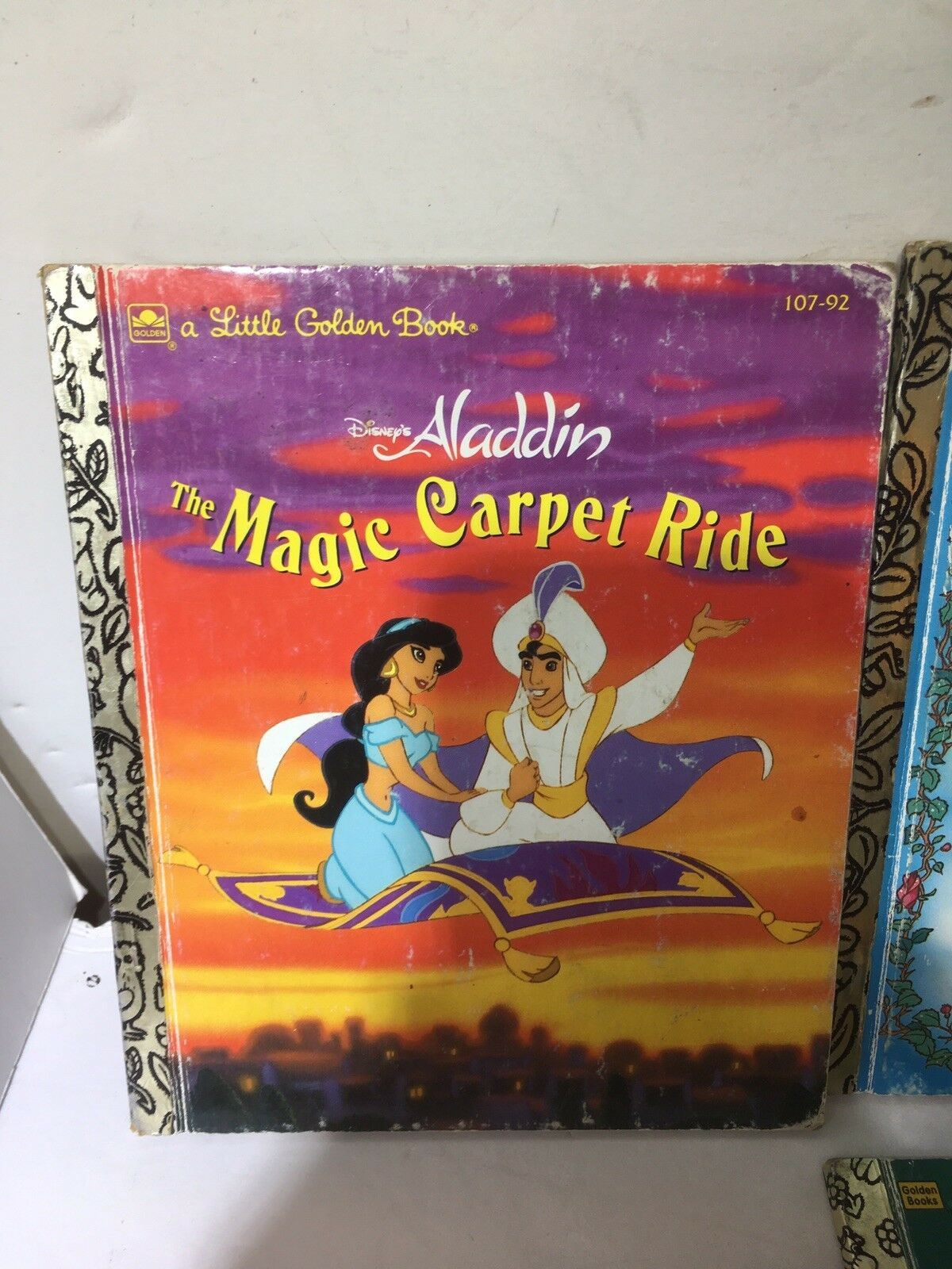 Cover of Disney's Little Golden Book 'Aladdin: The Magic Carpet Ride', featuring Aladdin and Princess Jasmine, part of a collection of 6 Little Golden Books including Bambi, Pocahontas, Beauty and the Beast, and Monsters. Perfect for collectors and young readers.