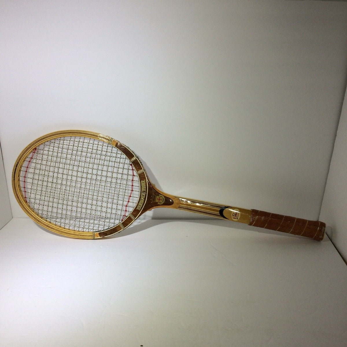 Vintage Tournament Wood Tennis Racket Ash Frame 9 Ply Andia displayed upright, showcasing its classic design and wood craftsmanship.