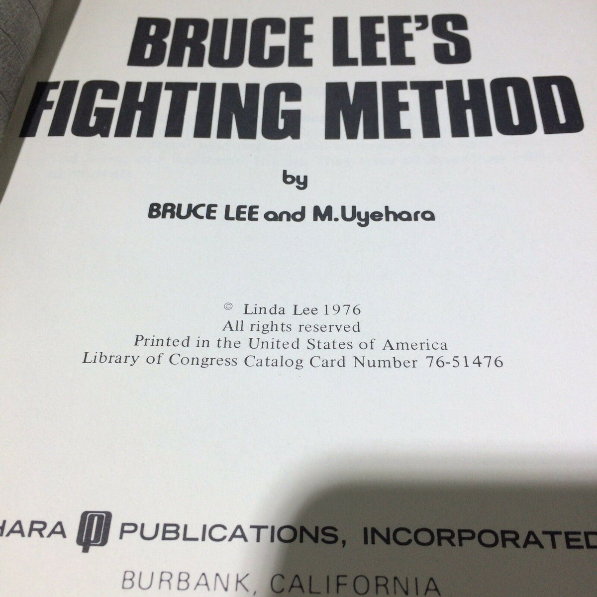 Title page of '1976 Bruce Lee’s Fighting Method Self-Defense Techniques' featuring author names Bruce Lee and M. Uyehara.